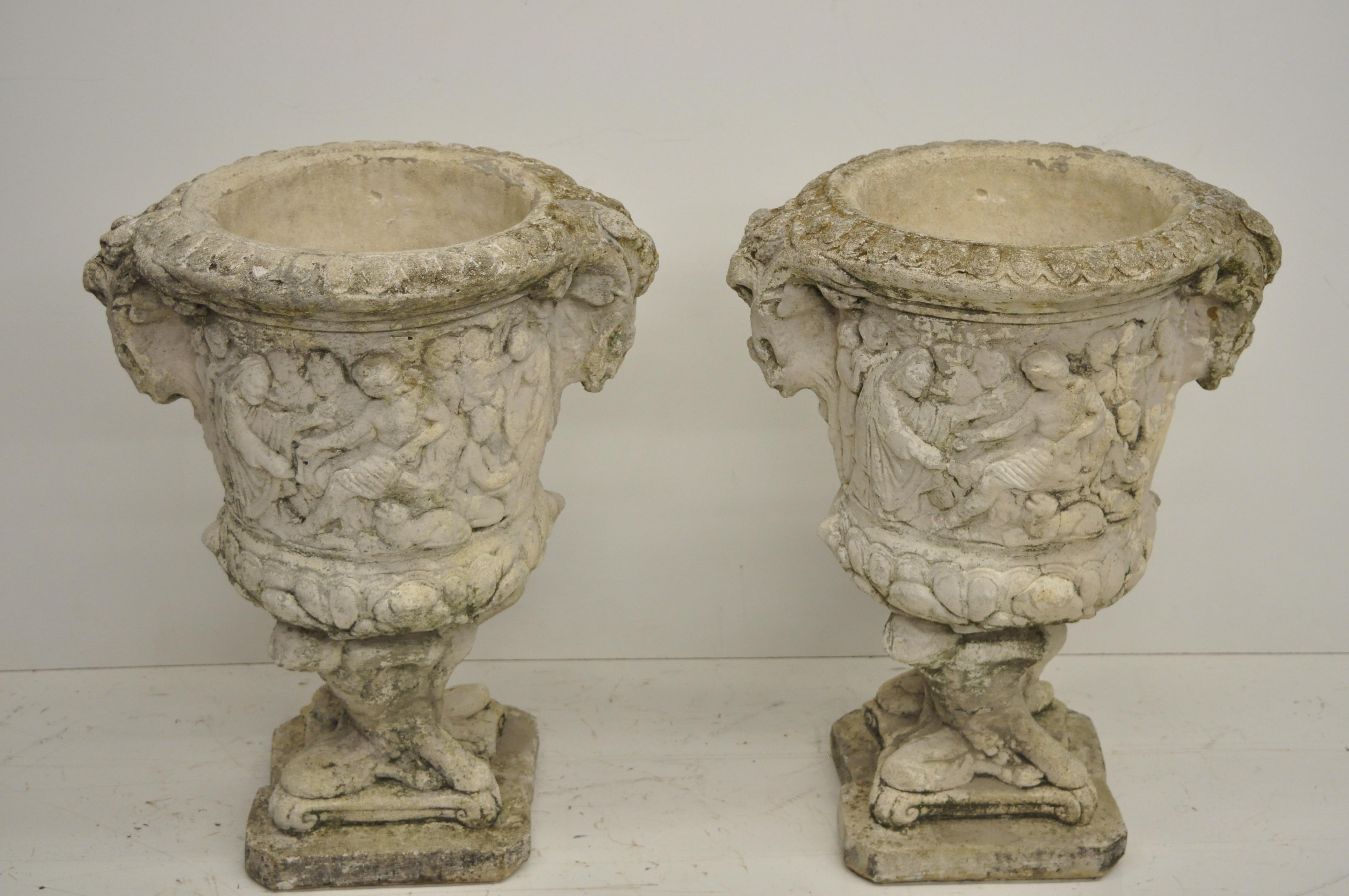 Antique pair of urn form concrete figural planters with Greek Classical scenes. Item features different scenes on front and rear, various male and female relief figures, authentic weathered patina, approximate 100 lbs. each, very impressive antique