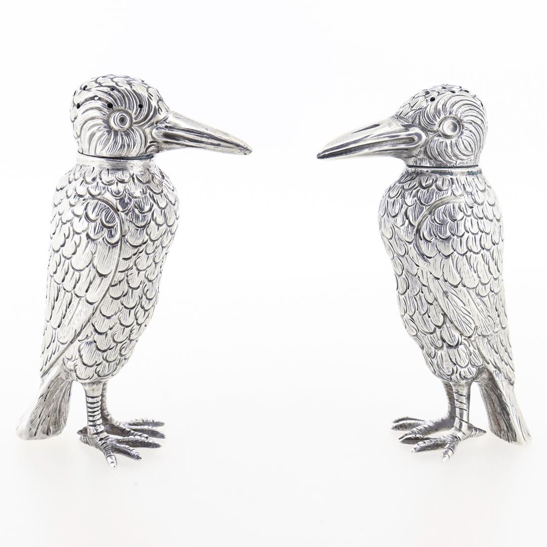 A fine pair of figural salt & pepper shakers.

In sterling silver.

In the form of 2 crows standing erect (or possibly another bird species).

Marked to the Sterling to the interior rim.

Simply wonderful shakers!

Date:
20th Century

Overall