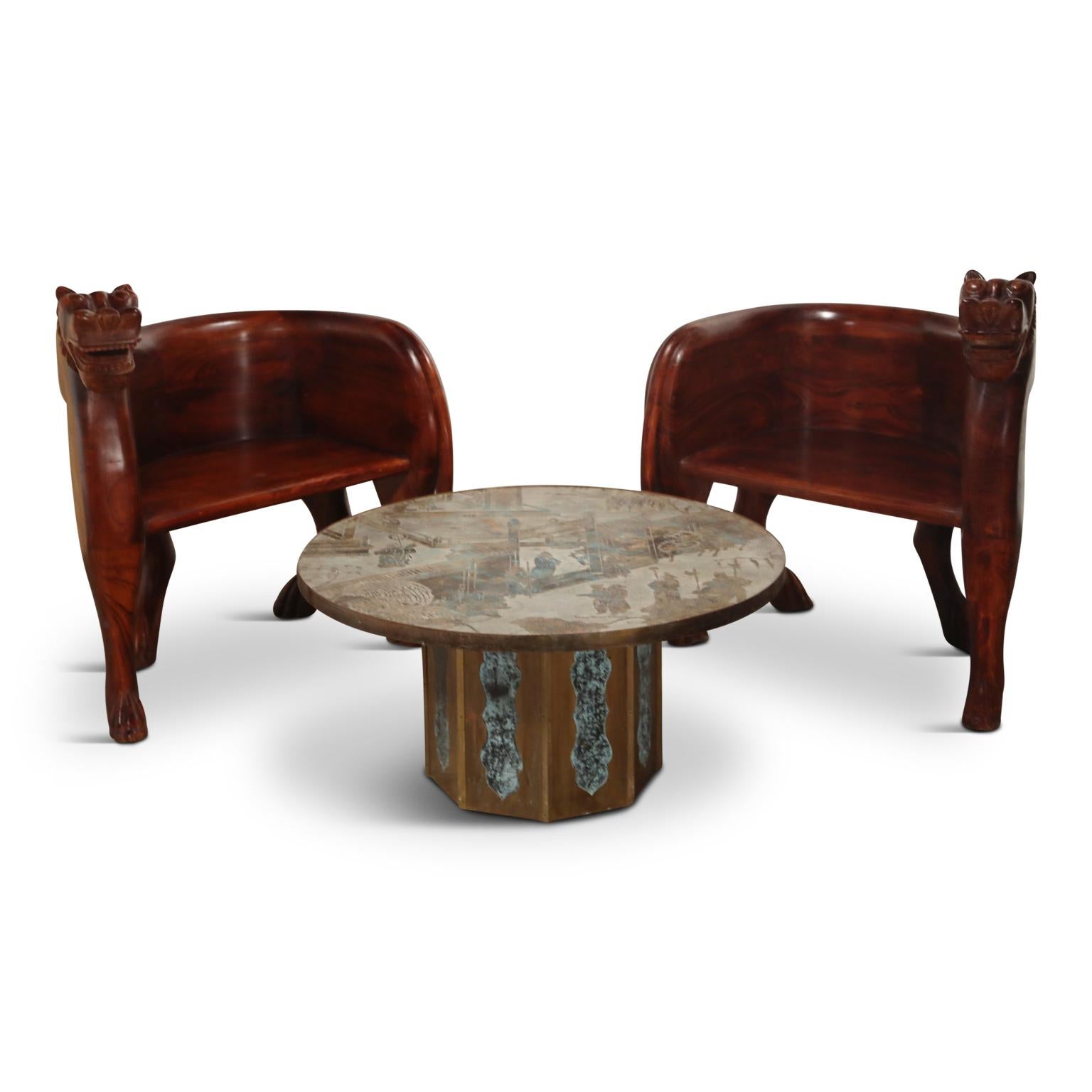 This spectacular pair of hand carved teak lioness club chairs are front-cover-magazine-worthy and can add a bit of the unexpected to any style of room. The color is a deep reddish brown that more closely resembles rosewood or Brazilian Jacaranda