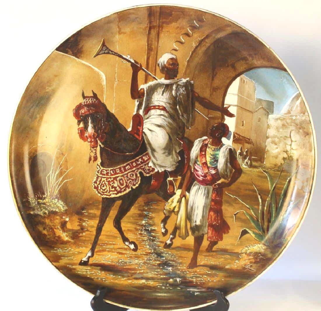 Our two painted porcelain chargers from Bernardaud of Limoges, France, date from circa 1910 and depict Arabian fighters on horseback. Each signed Dusson and one carries the additional signature Cojou.