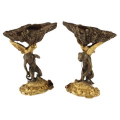 Pair of Figural Patinated & Gilt Bronze Garnitures with Shell-Form Bowl