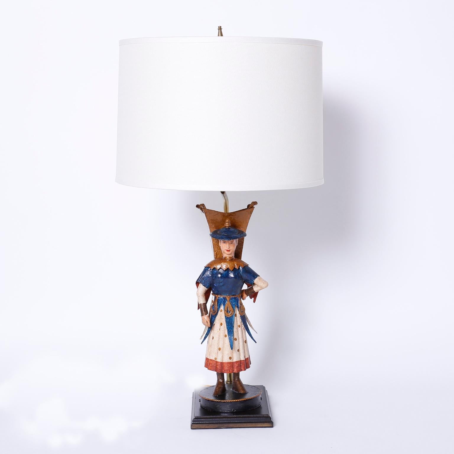 Eccentric pair of vintage tole or painted metal table lamps depicting
female and male Asian figures dressed in dramatic attire.