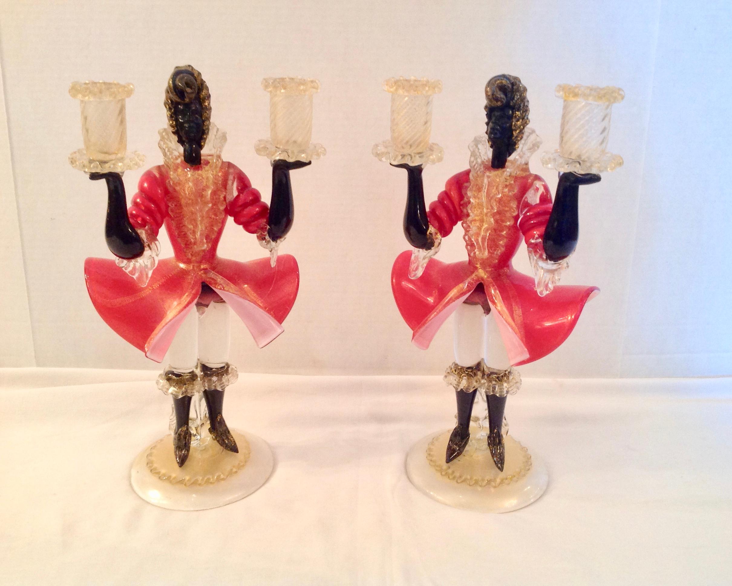 Elaborately garbed and finely fashioned blown glass in the Italian tradition.
Each holds candles in its outstretched arms. Dramatic details, color, and scale.
The figures are dressed in 