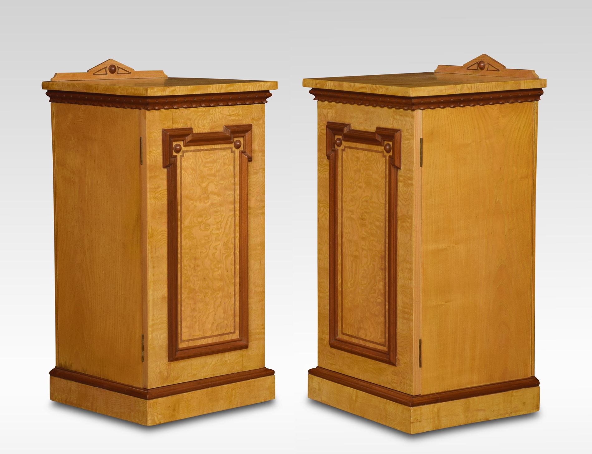 A pair of ash bedside cabinets having architectural raised back to the square top above carved mahogany freeze the door opening to reveal a single drawer and shelf. All raised up on plinth base. (adapted)
Dimensions
Height 33 inches
Length 16