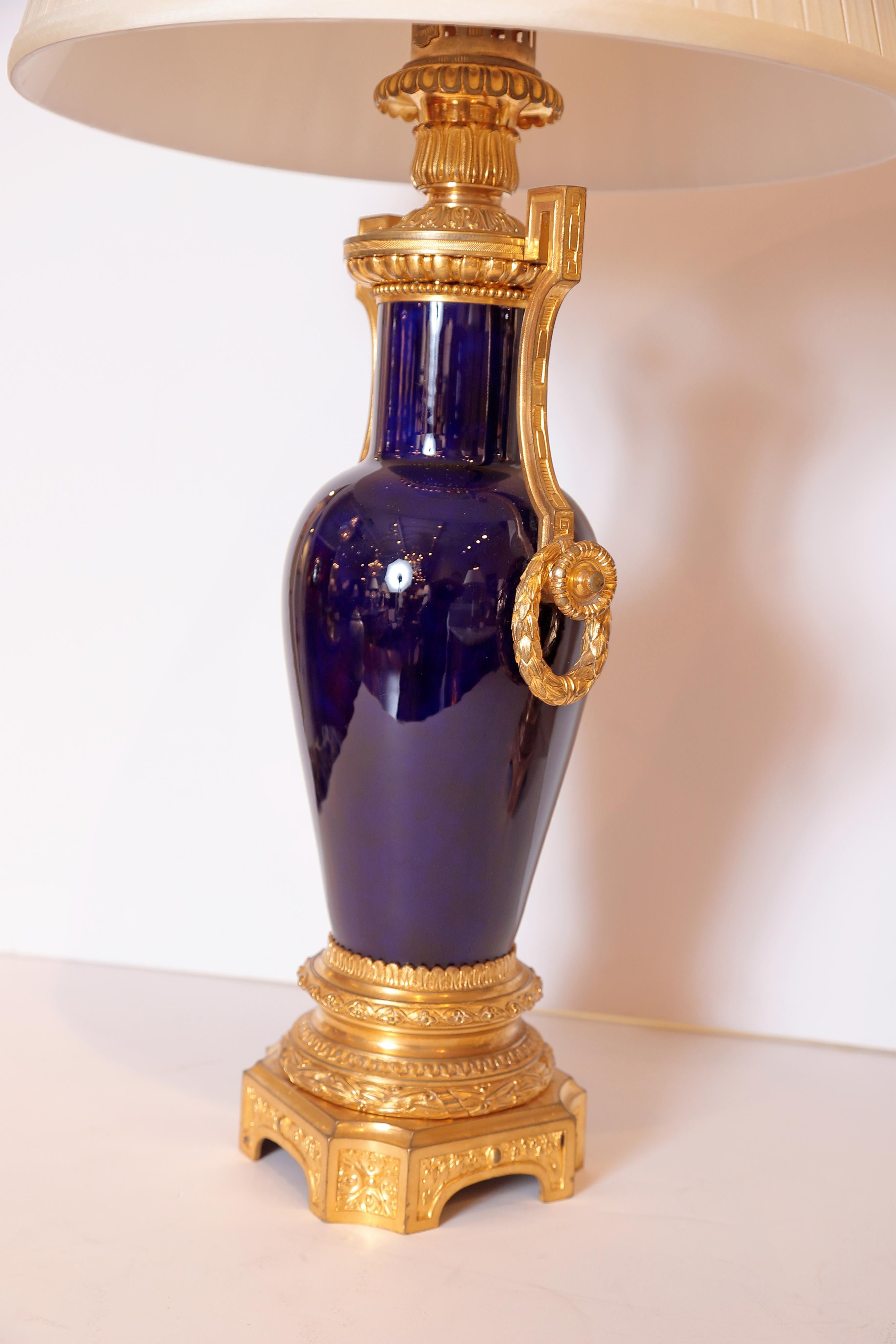 A pair of very fine French sevres style porcelain and gilt bronze urns converted into lamps. Signed Gagneau Paris.