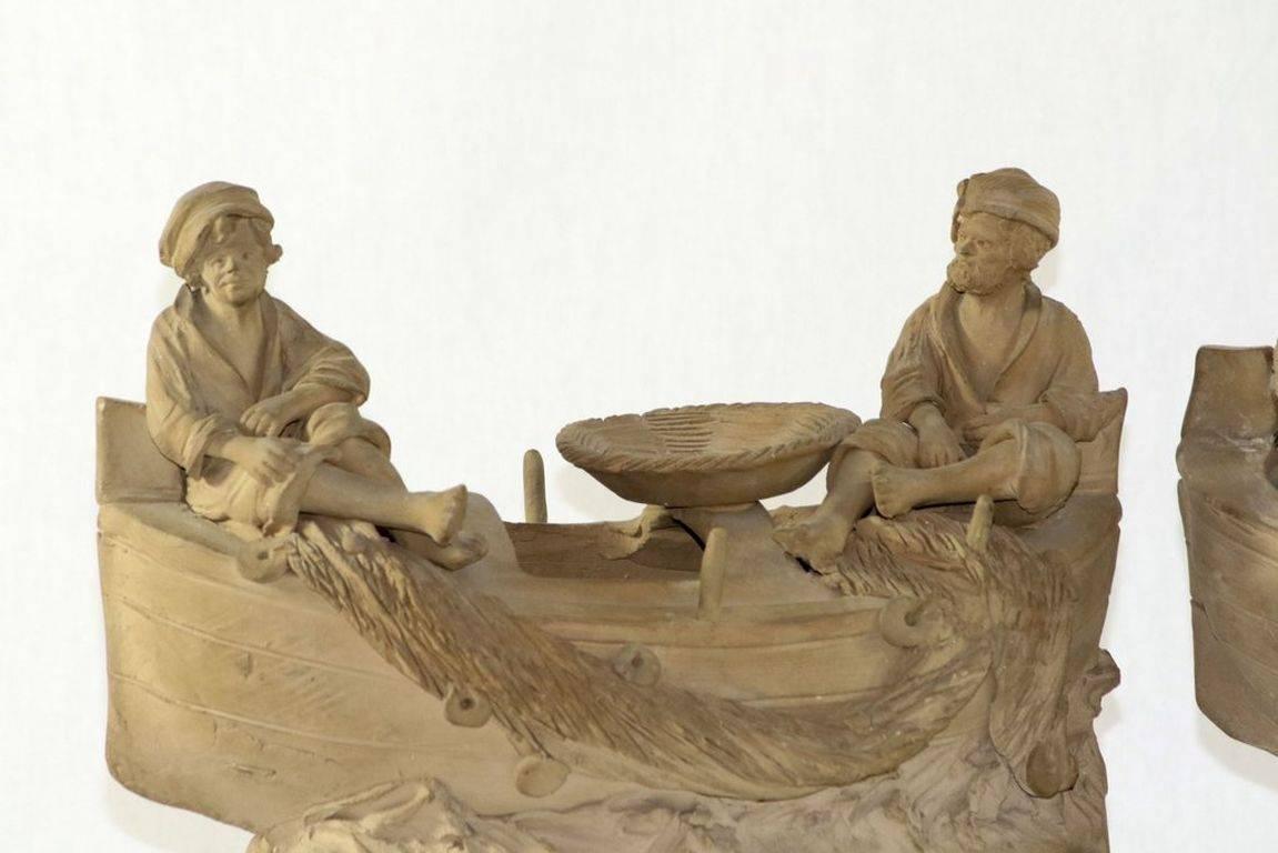 This is a fine pair of complimentary terracotta works from the prominent sculptor, Cavaliere Giuseppe Vaccaro of the famous Bongiovanni-Vaccaro workshop in Caltagirone (Sicily), Italy. Each features a pair of young fishermen with their nets yet cast