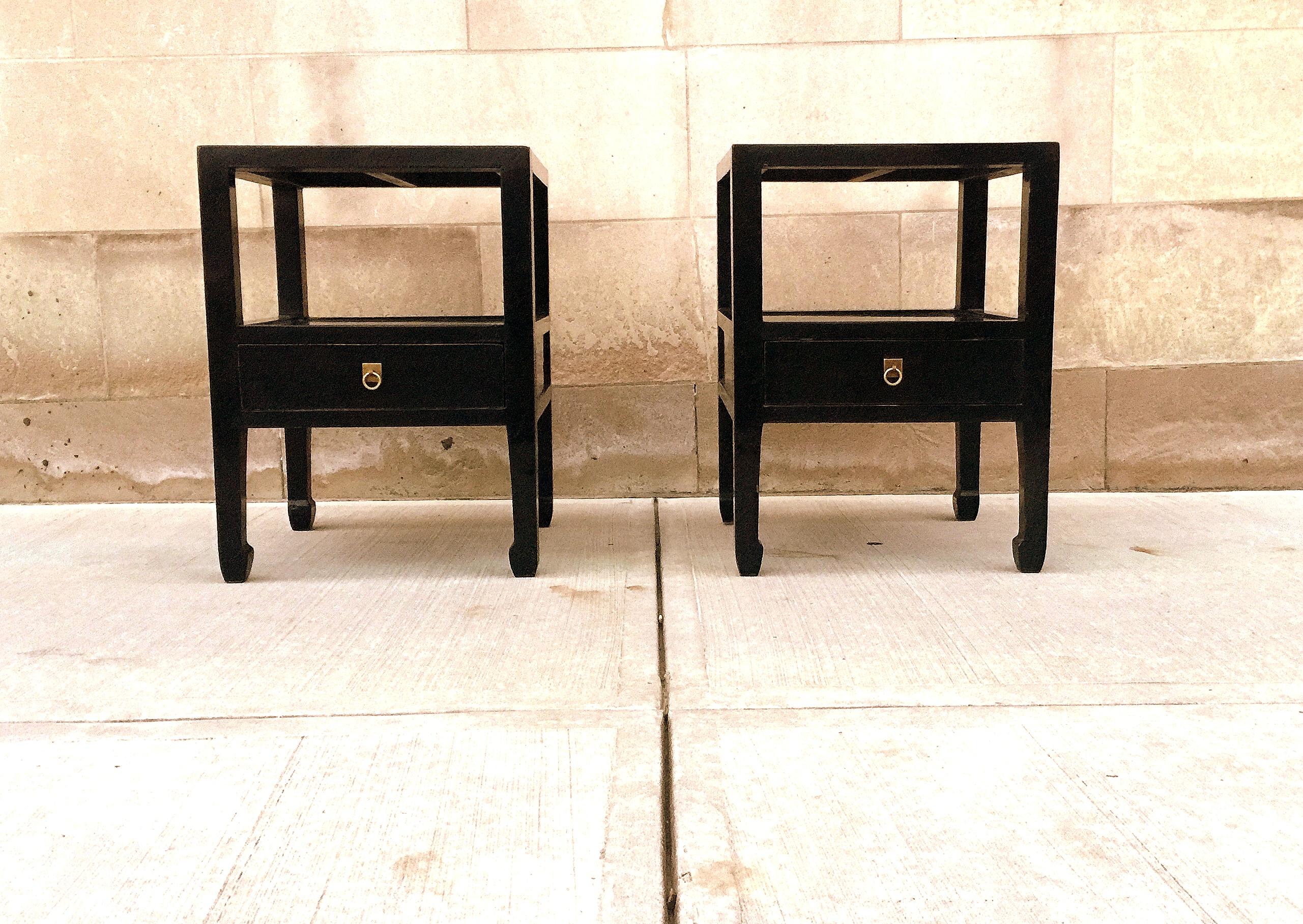 Pair of fine black lacquer end tables with one drawer with shelf, brass ring pull. We carry fine quality furniture with elegant finished and has been appeared many times in 