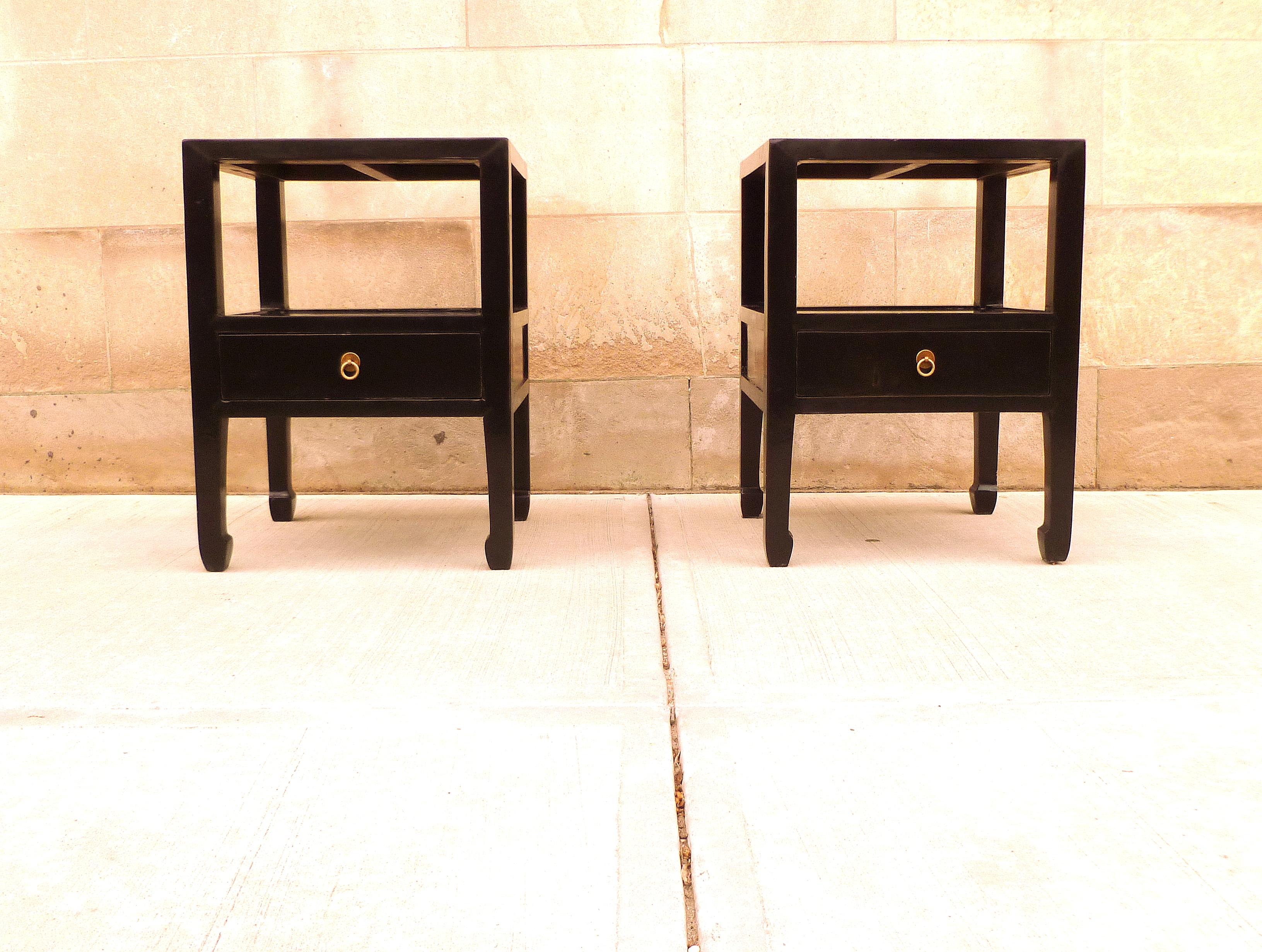 Pair of fine black lacquer end tables with one drawer with shelf, brass ring pull. We carry fine quality furniture with elegant finished and has been appeared many times in 
