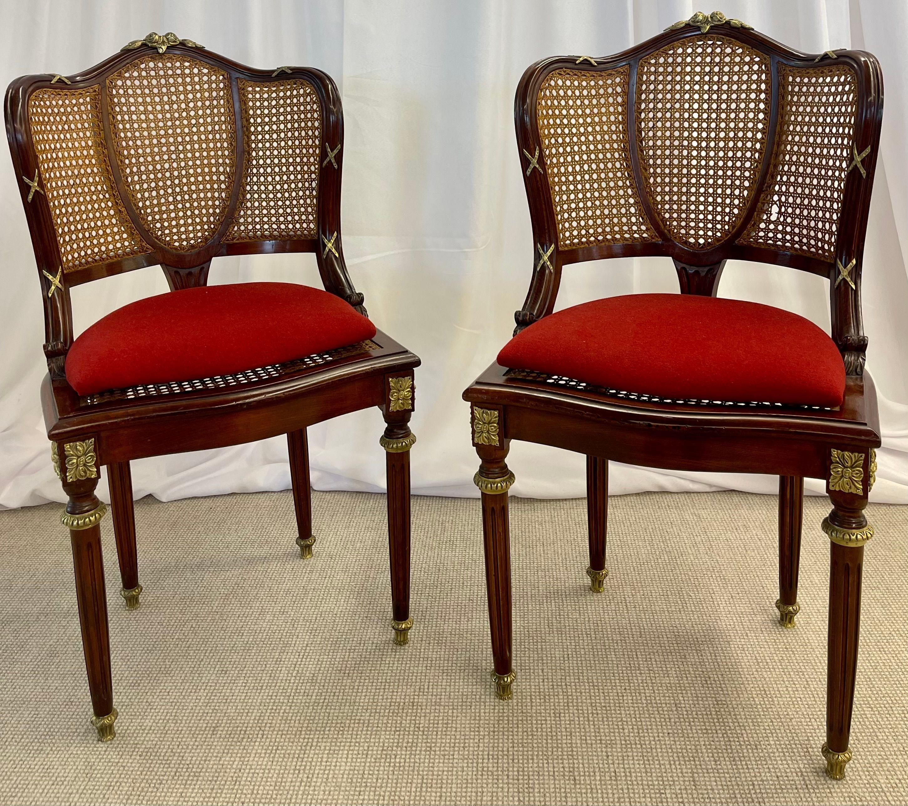 Pair of fine bronze-mounted Louis XVI style dining chairs. This is a simply magnificent pair of Maison Jansen fashioned solid mahogany dining chairs each having all-over bronze mounts. This pair having recently been cleaned and the wood French