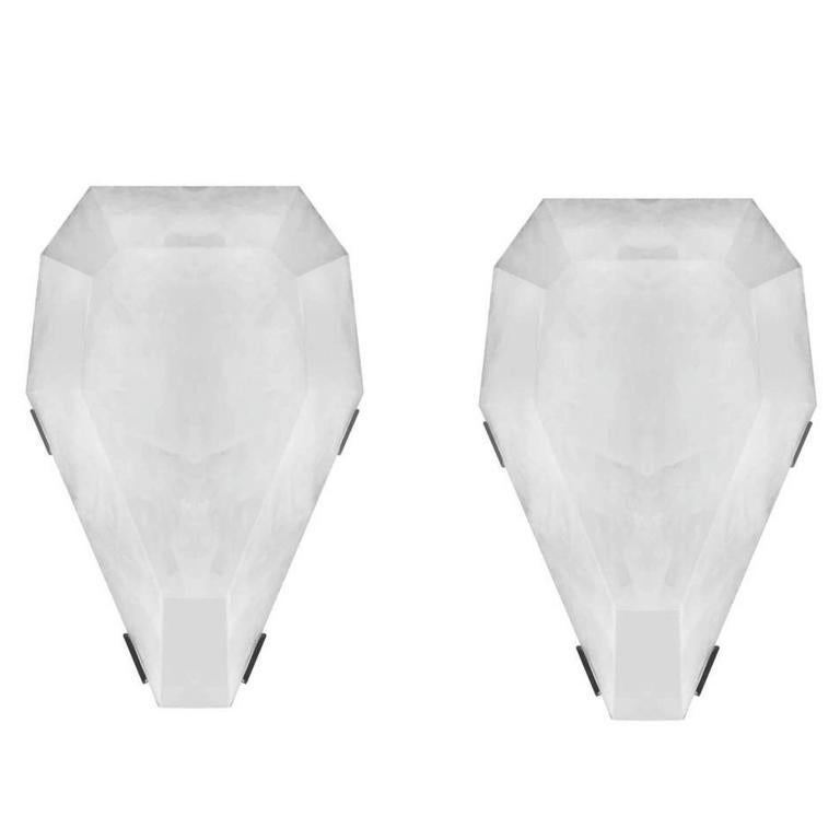 Pair of fine carved diamond form rock crystal quartz sconces with antique brass mounts, created by Phoenix Gallery, NYC.
Each sconce has two sockets with candlelight bulbs max of 80W.
Custom measurement and finish available.
Measures: 15 in/H x 11