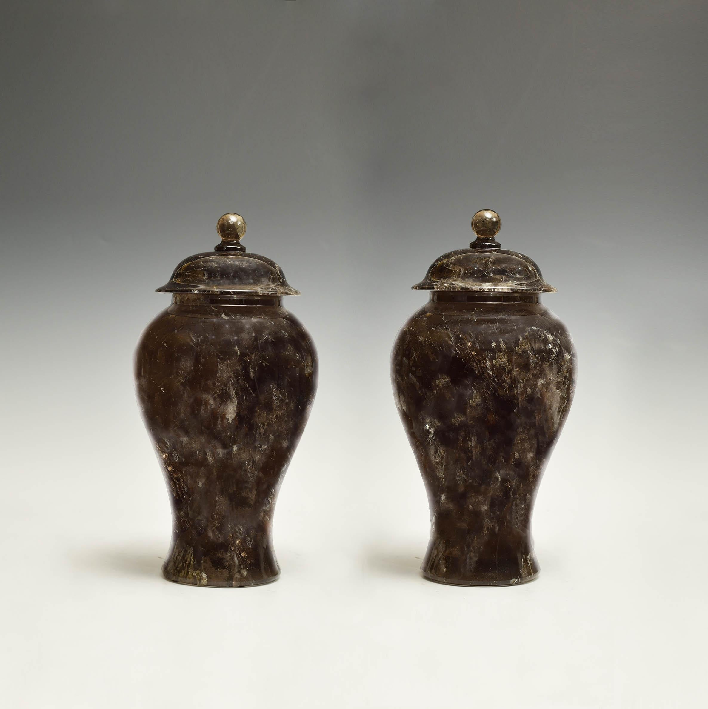 A pair of fine carved solid smoky rock crystal jars. (cannot open) Created by Phoenix Gallery.
 