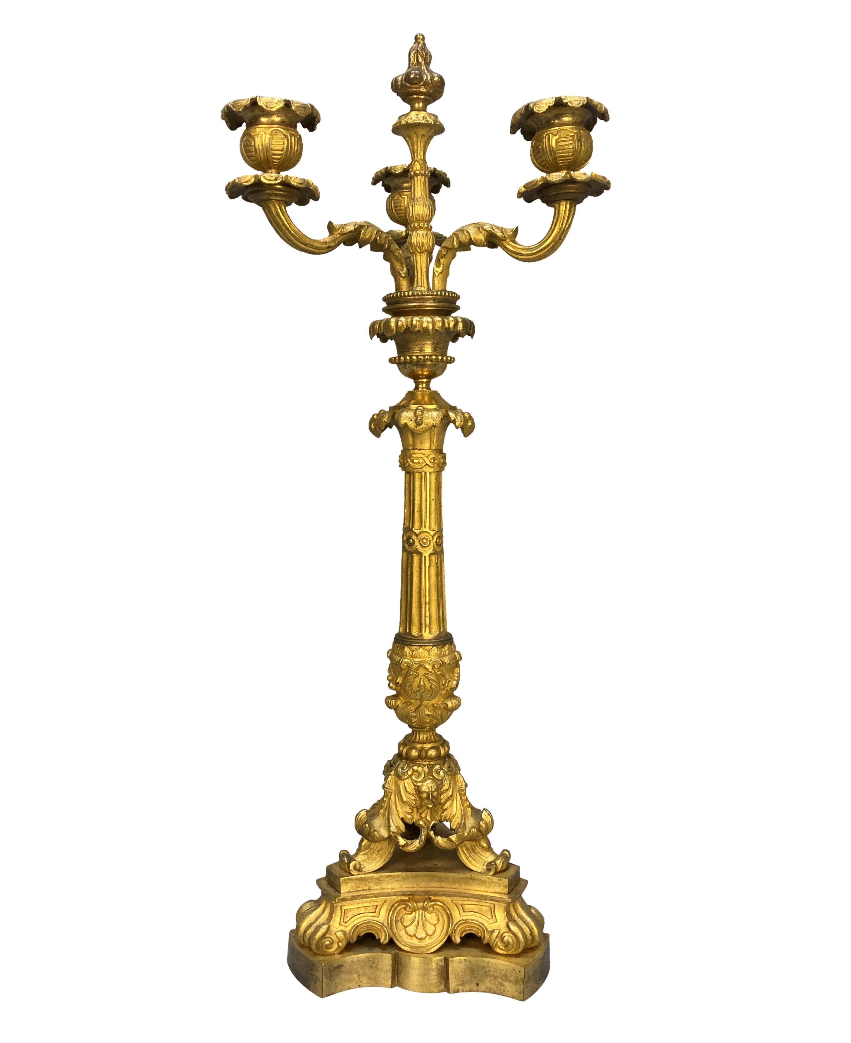 A fine pair of French Charles X ormolu (gilt-bronze) candelabra, beautifully and crisply cast, with hand burnishing in places. With three branches and a central flambe. Acanthus decoration throughout with scrolls and masks.