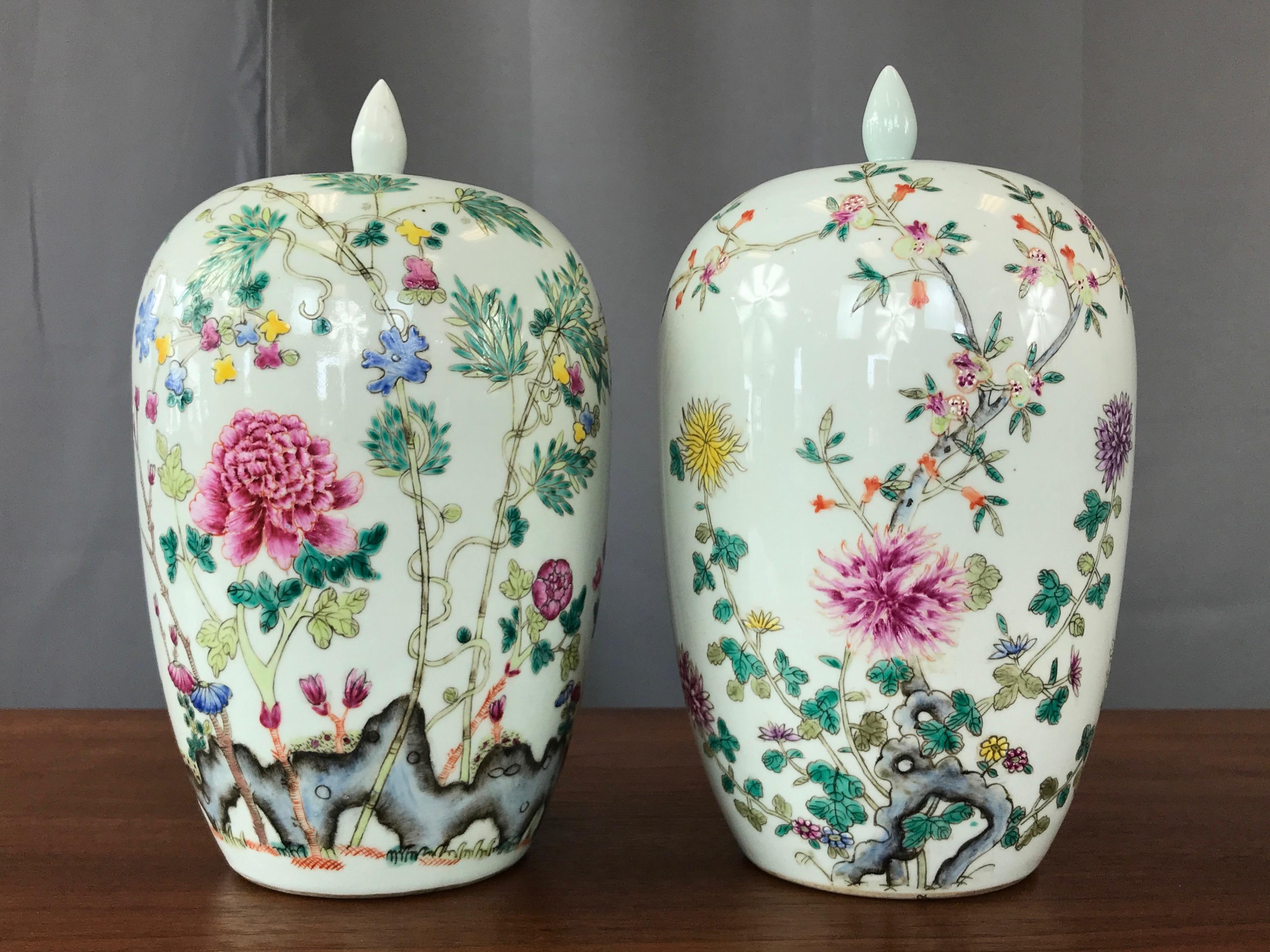 A pair of very fine Chinese Famille Rose porcelain covered vases or jars from the Guangxu Period (1875–1908).

Each pear form finely painted with a large flowering peony or chrysanthemums in a rocky garden. Each vessel marked on base with iron red