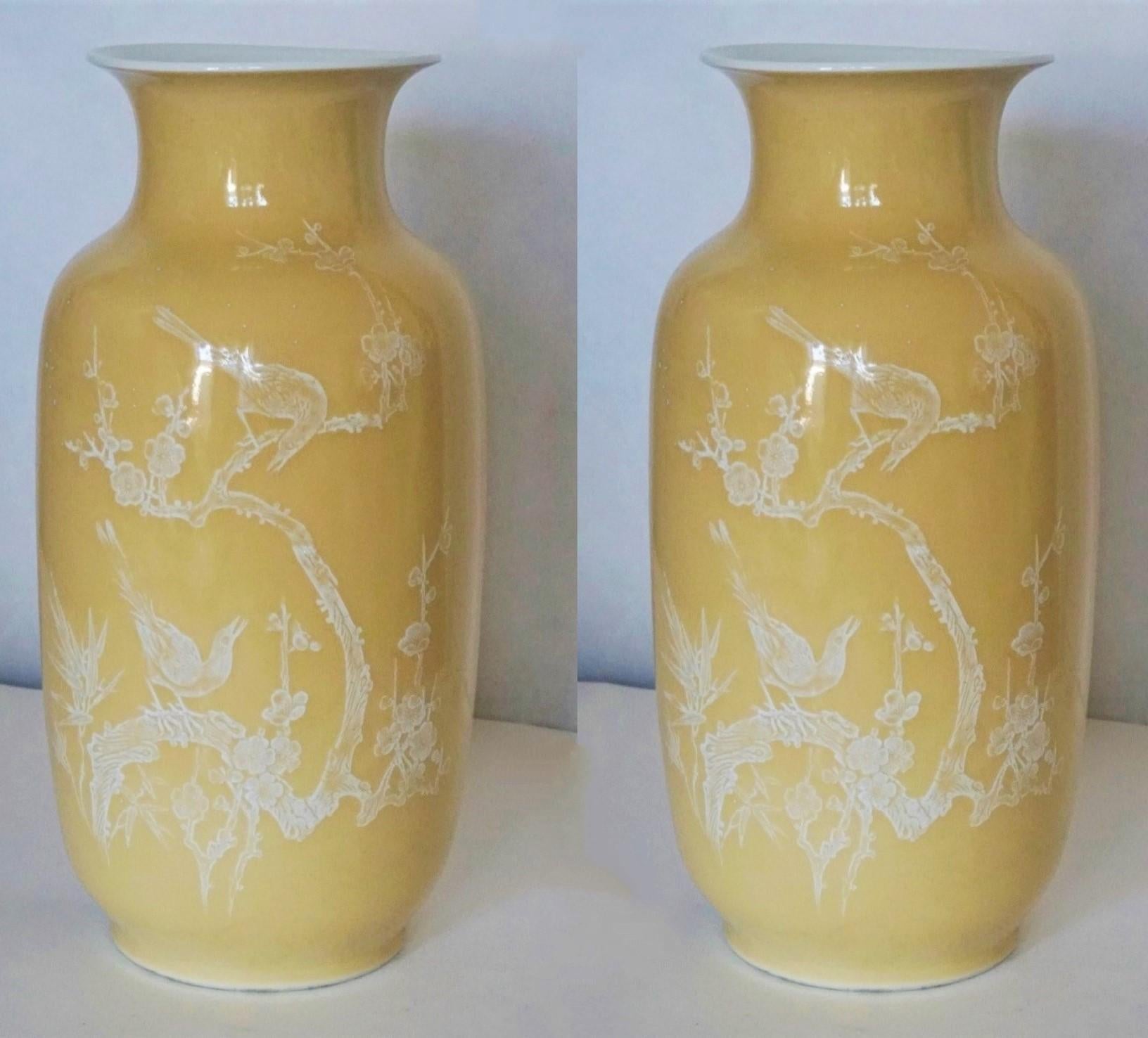 A pair of large, fine Chinese porcelain yellow-ground vases decorated with hand-painted birds and floral motifs on both sides, China, early 20th century. Each vase marked at the bottom.
Condition: Both vases in fine original condition, some wear, no