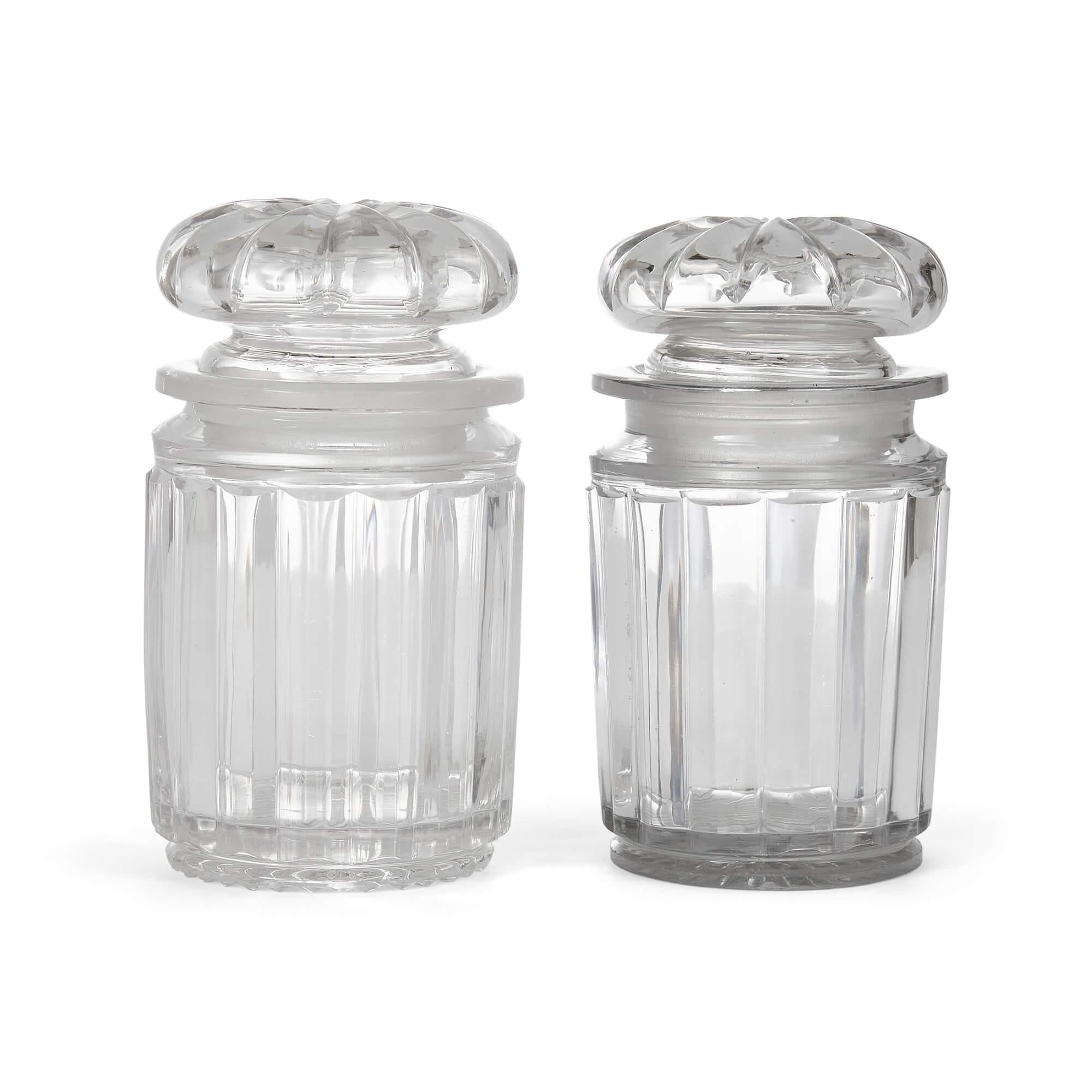 Pair of fine English glass jars with fitted stoppers.
English, 20th century
Measures : Height 16cm, diameter 8.5cm

Of an elegant and simple design, immaculately finished, these fine glass jars were made in England in the course of the twentieth
