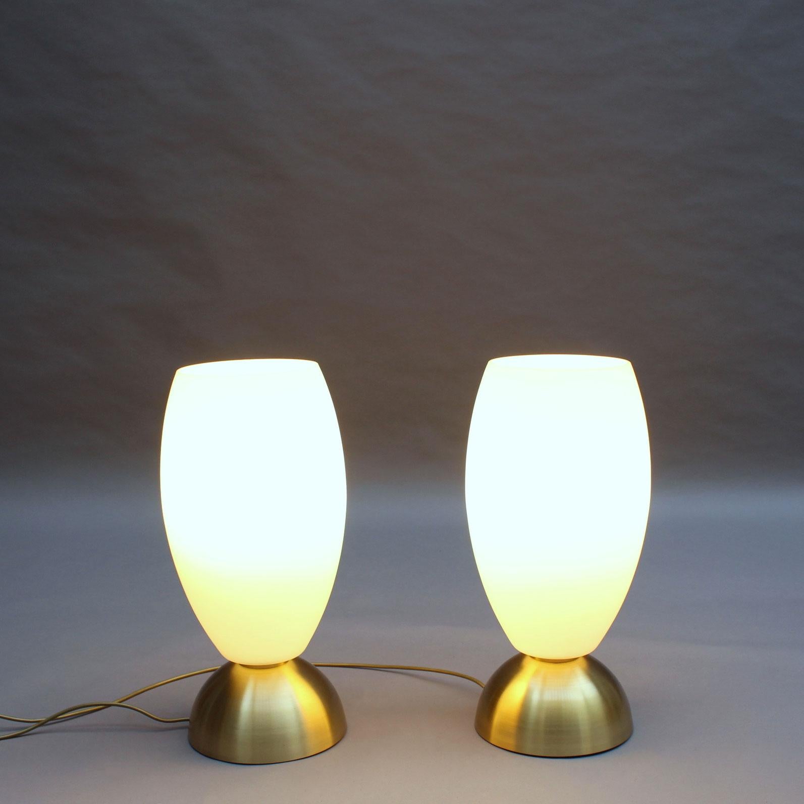 With a conical brass base that supports a frosted glass ogive shape diffuser.
Signed.