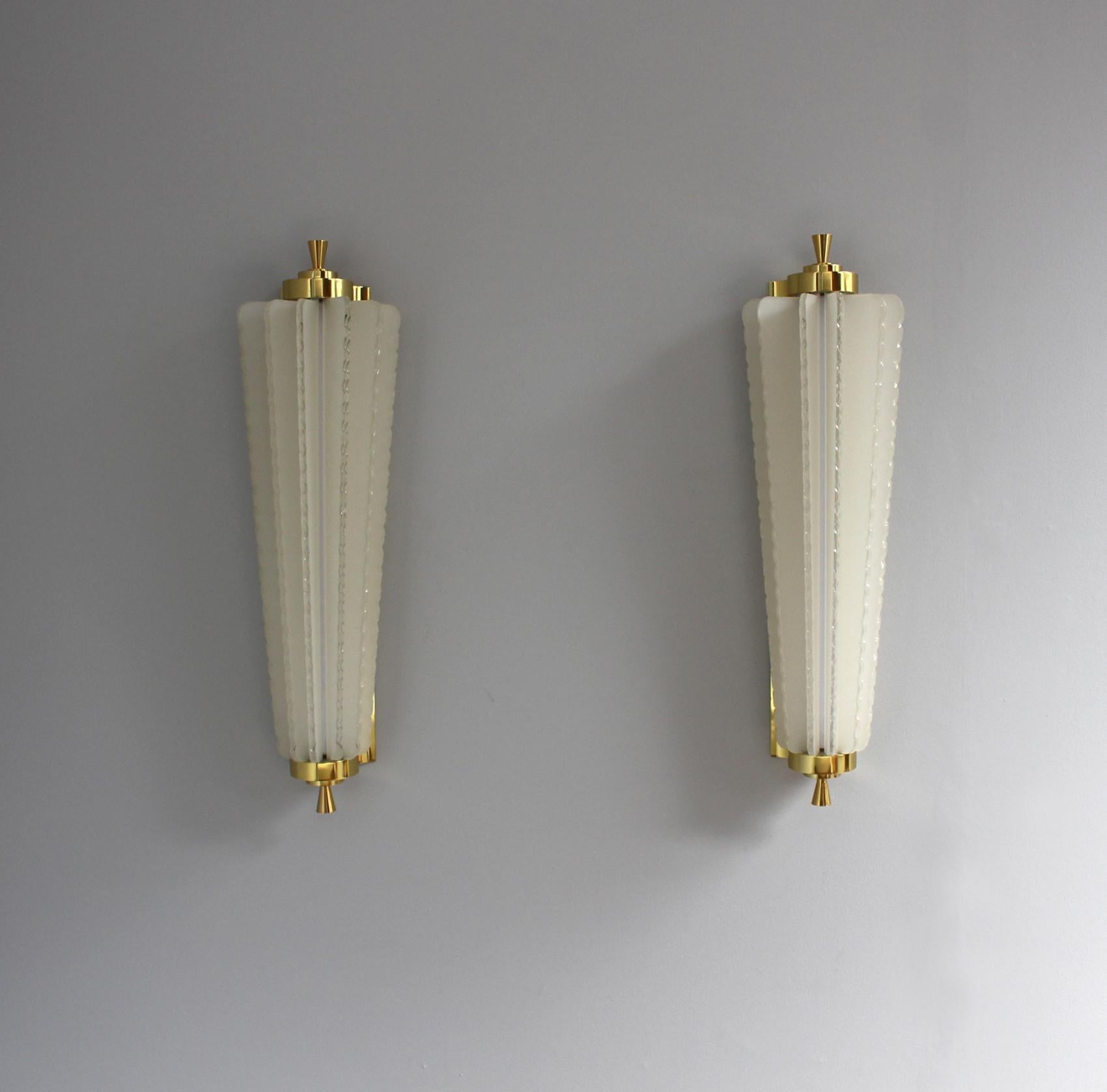 A pair of fine French 1930s wall lights with hand-cut frosted glass strips mounted in a bronze frame.