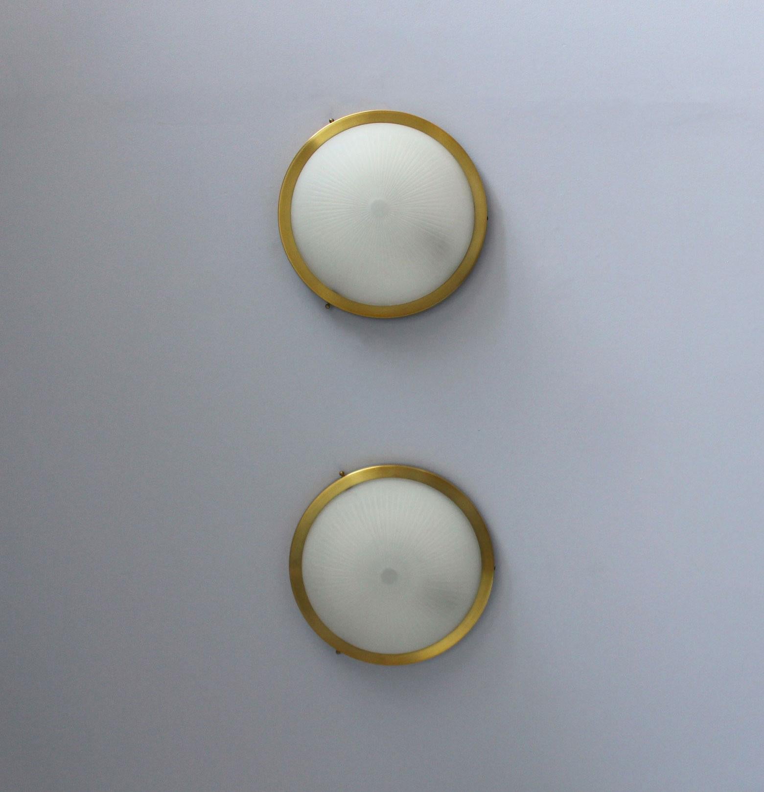 Avec une structure circulaire brossée satinée qui contient un diffuseur en verre dépoli cannelé.
