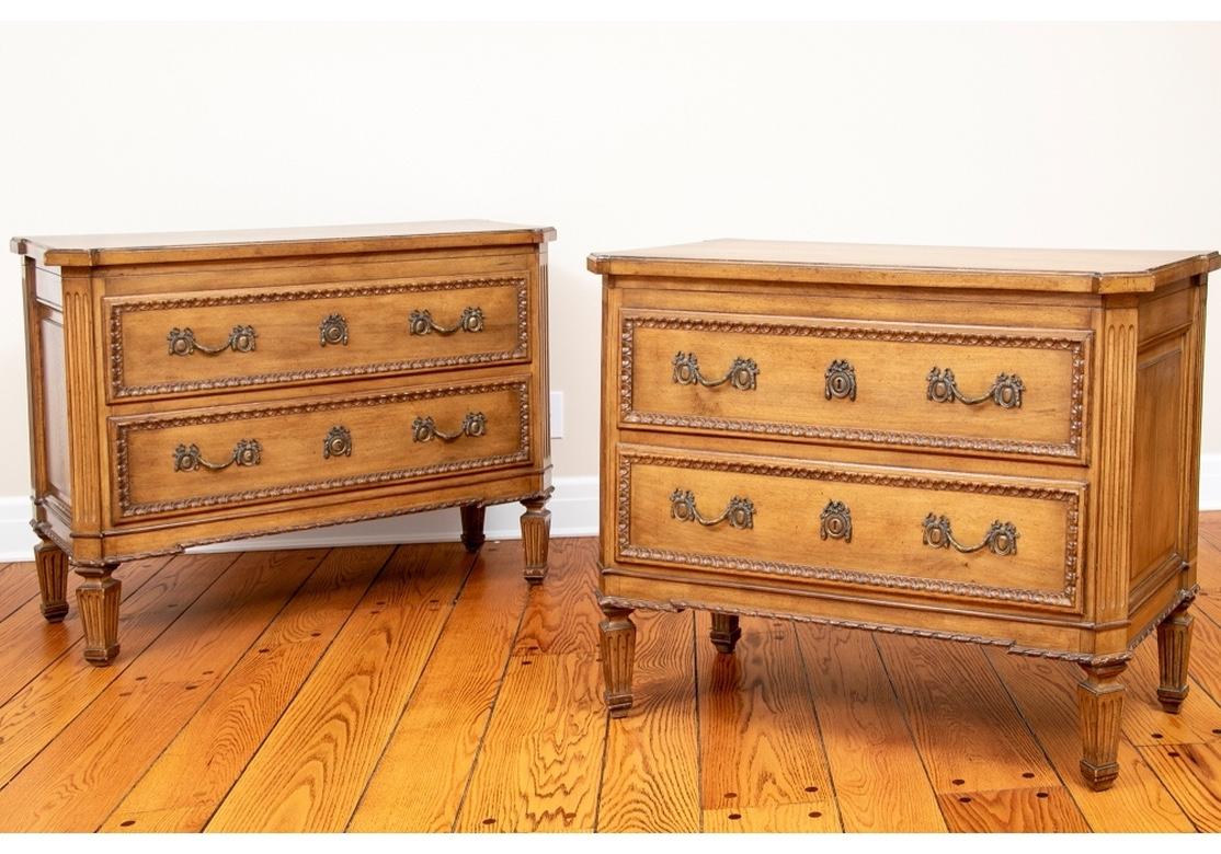 Pair of Auffray & Company fruit wood chests with two long drawers with compartments and carved leafy bands. The tops with canted corners in the front. With fluted supports and square tapering fluted legs. The skirt with carved running twist edges,