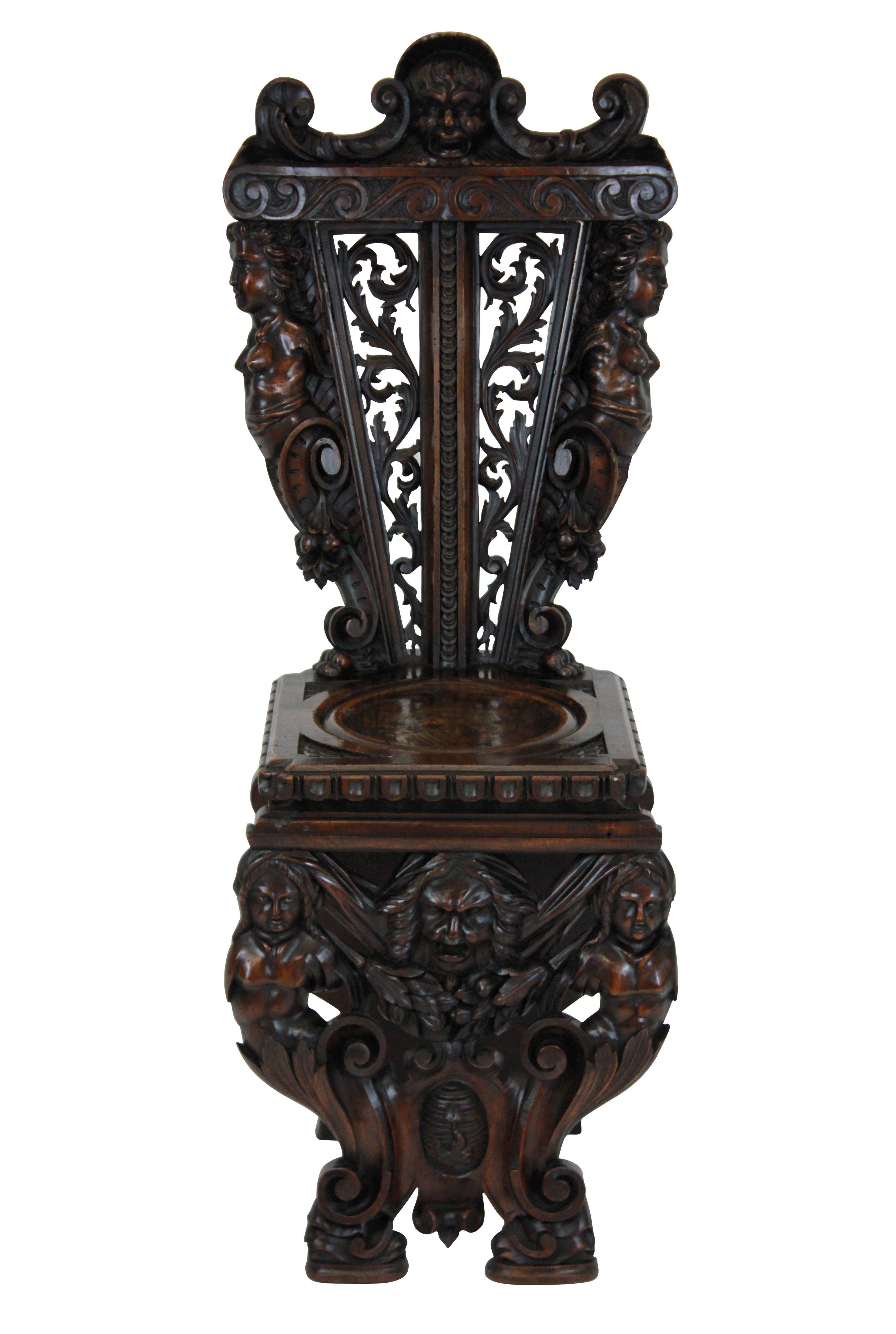 A pair of fine early 19th century Italian carved walnut hall chairs in the Renaissance style. Profusely and beautifully carved with foliage, caryatids and a coat of arms.

 