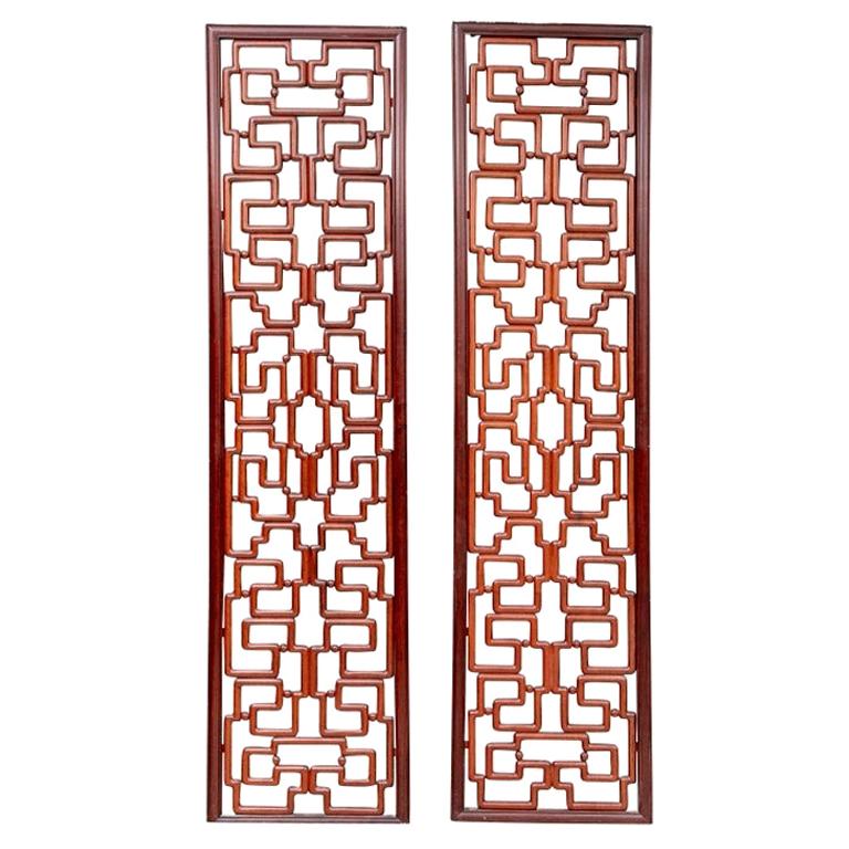 Tall exotic wood carved panels or screens with intricate interlaced thick angular overall patterns with knobs in between the frames.
Each Panel measures height 95