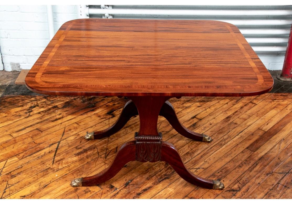 Possibly Scottish, circa 1820. Banded and burled tables with double pedestal supports with carved leafy center panels. Raised on banded legs. With serpentine stretchers. Lacking the original casters. The two can be put together as one
