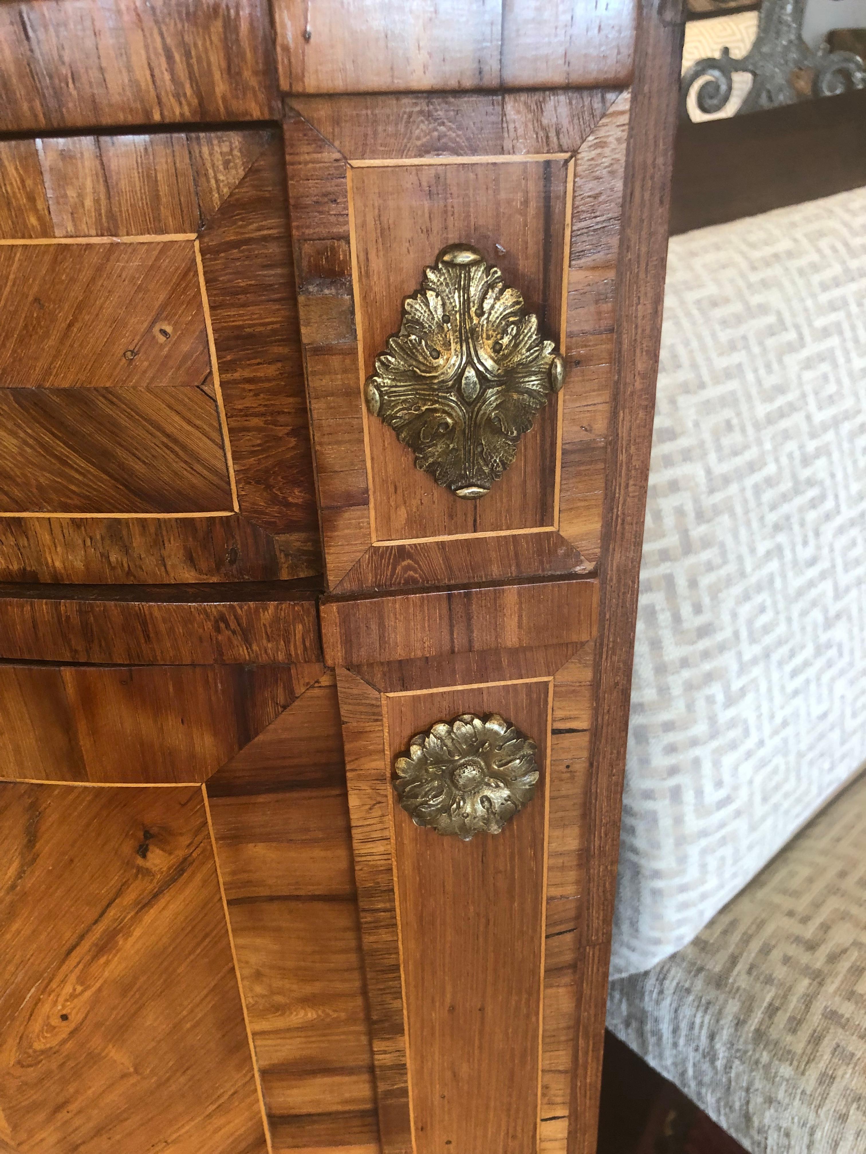 Fine 19th century pair of mixed wood inlaid corner cabinets having caramel colored marble tops, single drawer, and doors that open to reveal shelves and storage inside.  Original brasses are lovely.
