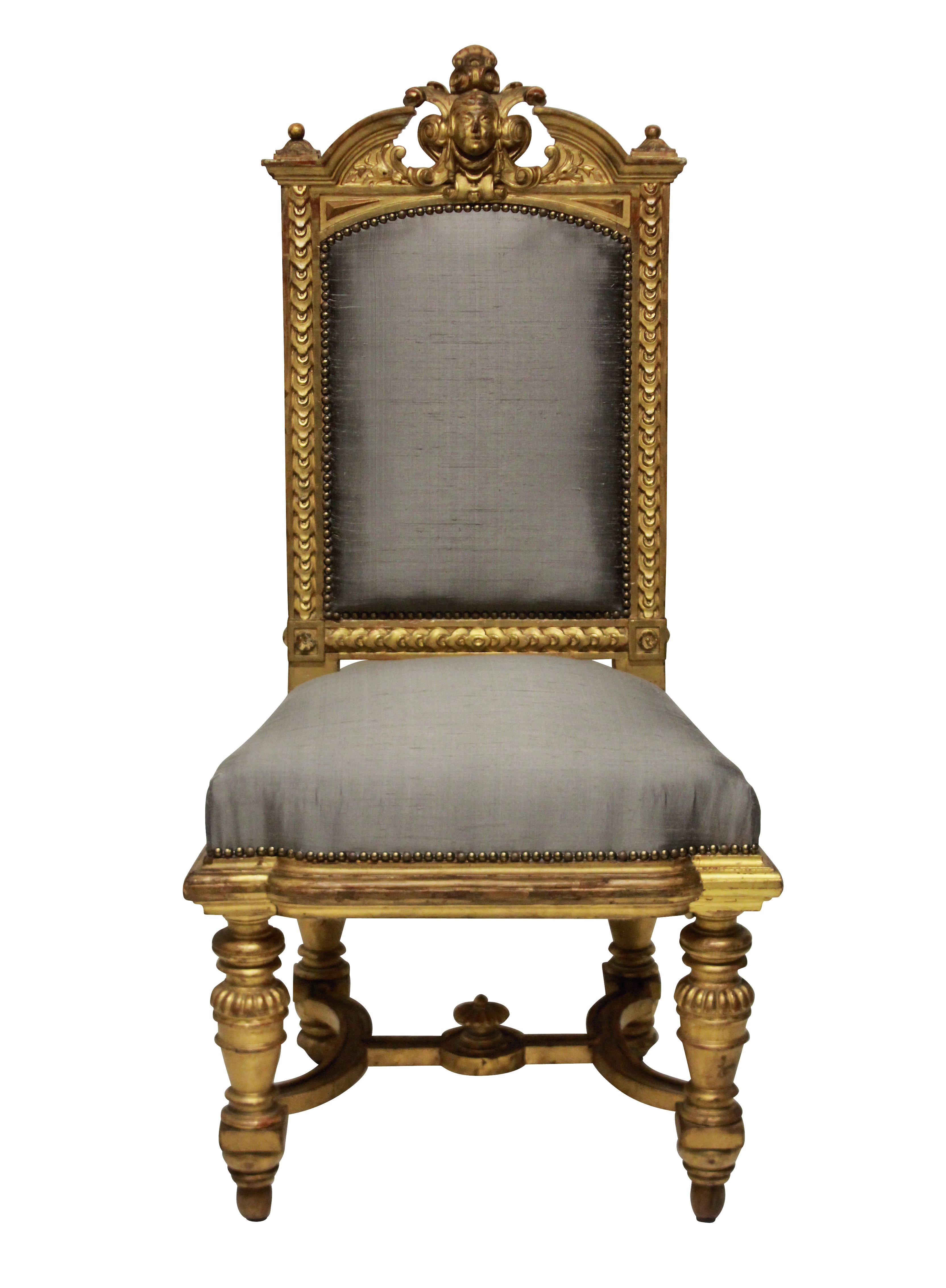 A pair of fine French Napoleon III water gilded chairs, beautifully carved and turned, with central female classical masks and burnished throughout. Newly upholstered in stone colored silk.
        
         