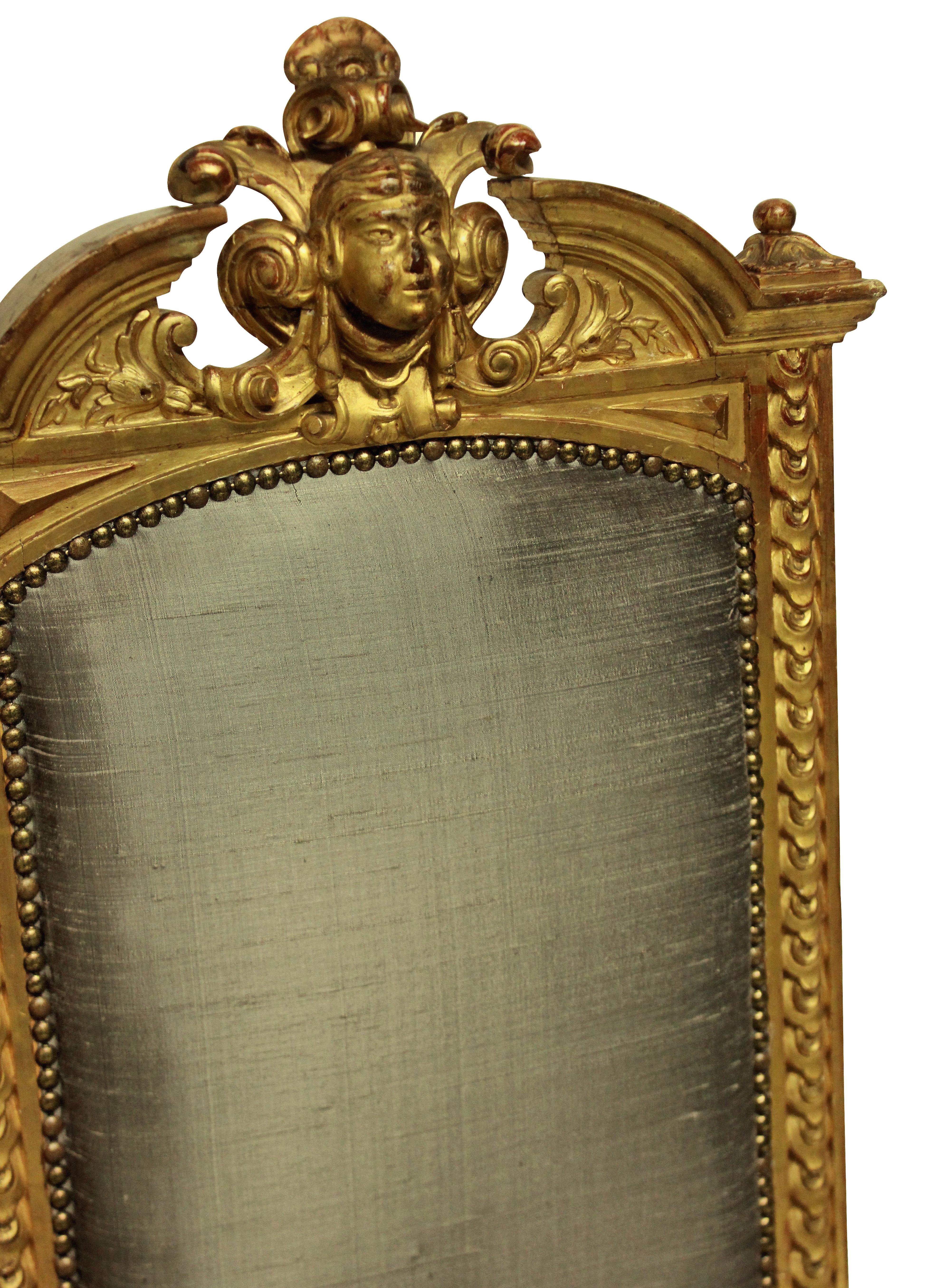 A pair of fine French Napoleon III water gilded chairs, beautifully carved and turned, with central female classical masks and burnished throughout. Newly upholstered in stone colored silk.

  