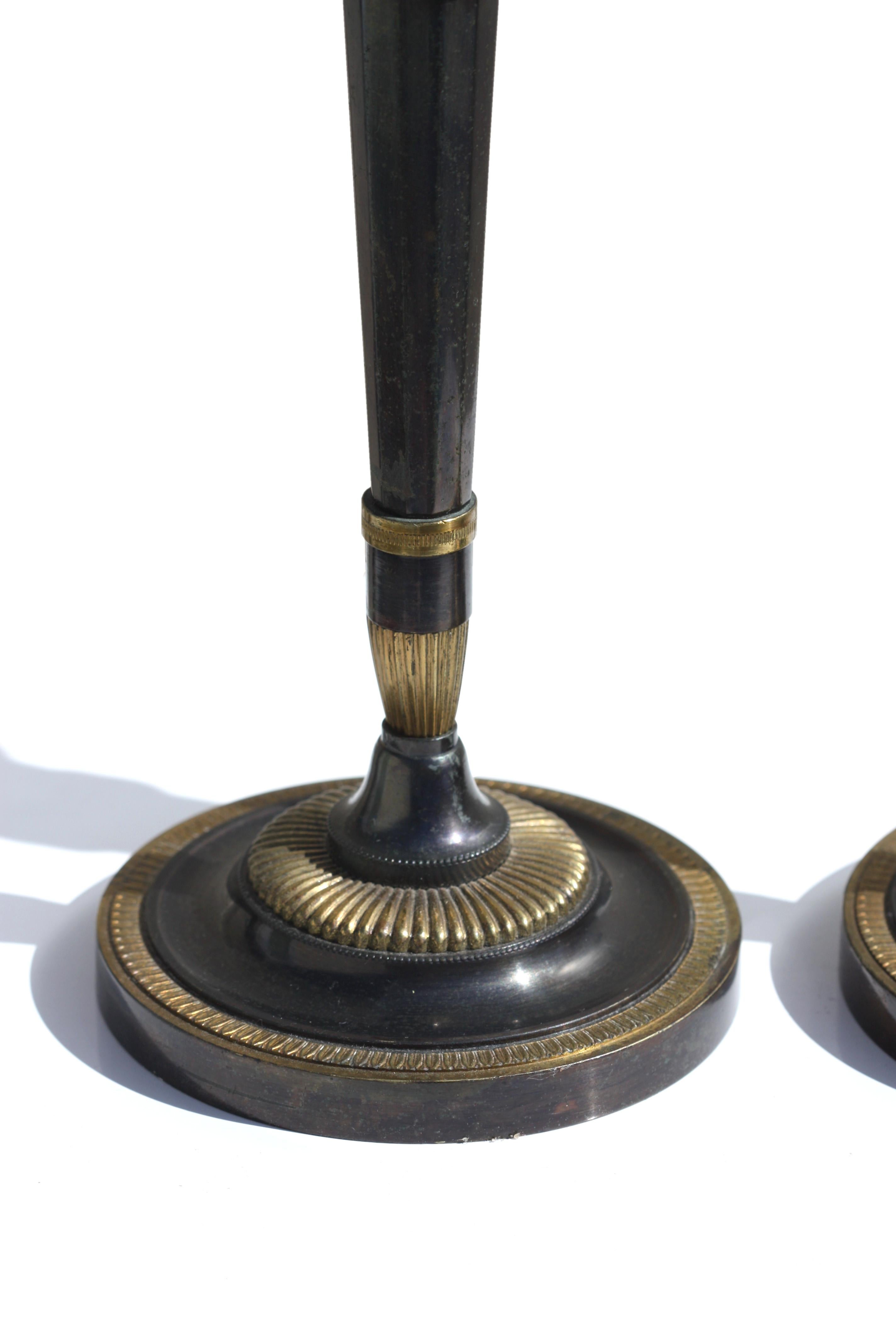 Pair of Fine Neoclassical Parcel Gilt Polished Steel Candlesticks In Good Condition For Sale In West Palm Beach, FL