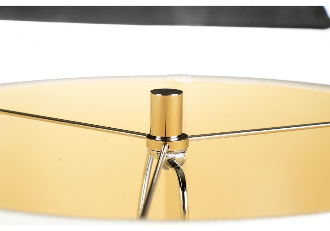 A pair of very well made and stylish heavy chrome obelisk form table lamps mounted on lucite plinth bases. Comes with white fabric covered drum shades and cylindrical chrome finials.

Dimensions: oval shade 14