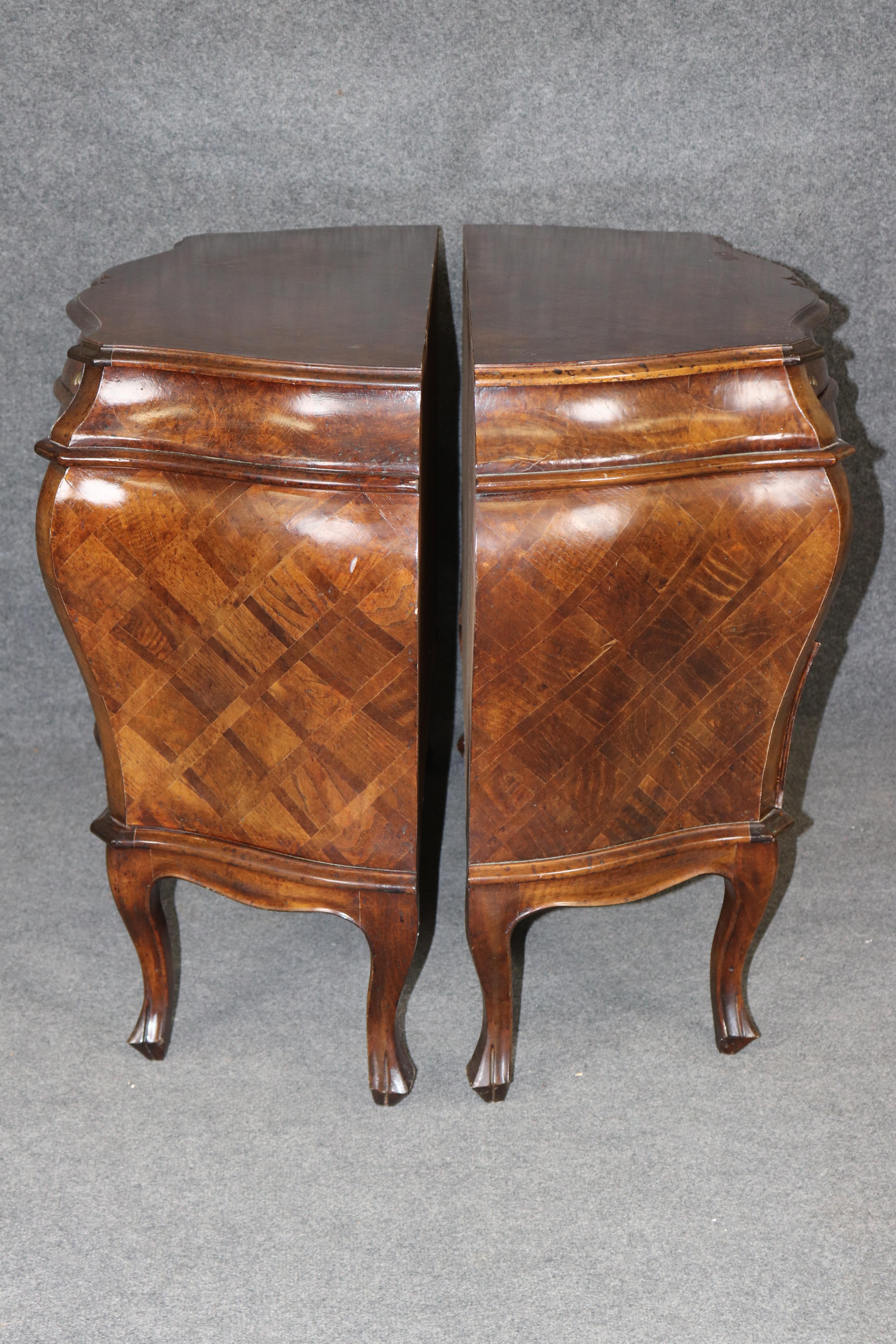 This is a gorgeous pair of marquetry olive wood commodes made in Italy.  They are in good used condition with minor signs of age and use, minor finish loss, dings and dents. Nothing significant. Dates to the 1950s era.

 They Measure 31 tall x 45