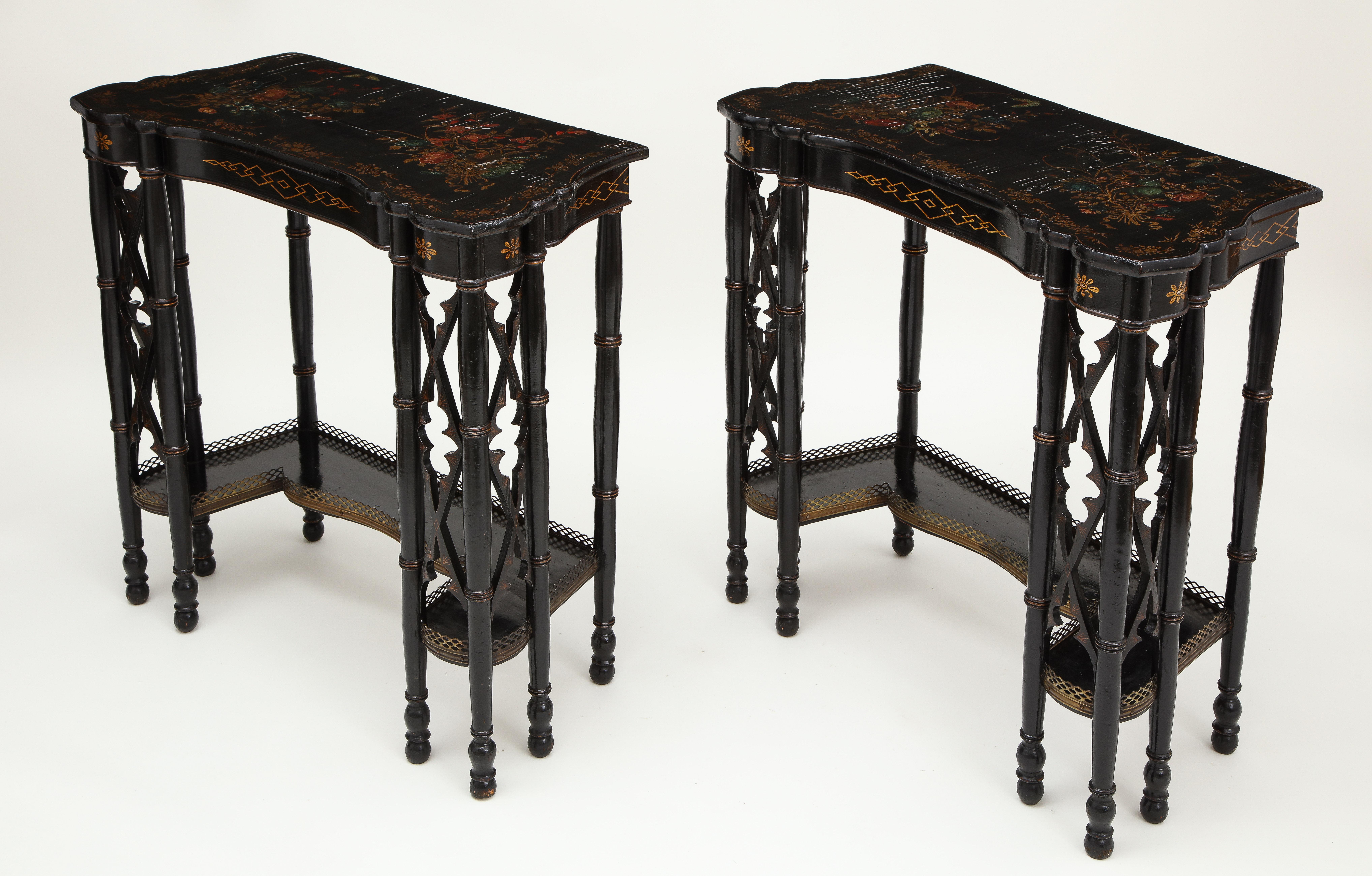 These unusual tables are designed to also be used back to back, and connect to make a square table if desired.

Each with eared slightly incurved tops with polychrome and gilt decoration of summer flowers and butterflies, over a narrow conforming