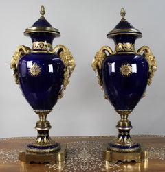 Pair of Fine Sèvres Style Cobalt Blue Porcelain Ram's Head Lidded Urns
