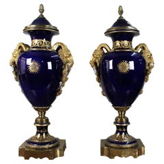 Pair of Fine Sèvres Style Cobalt Blue Porcelain Ram's Head Lidded Urns