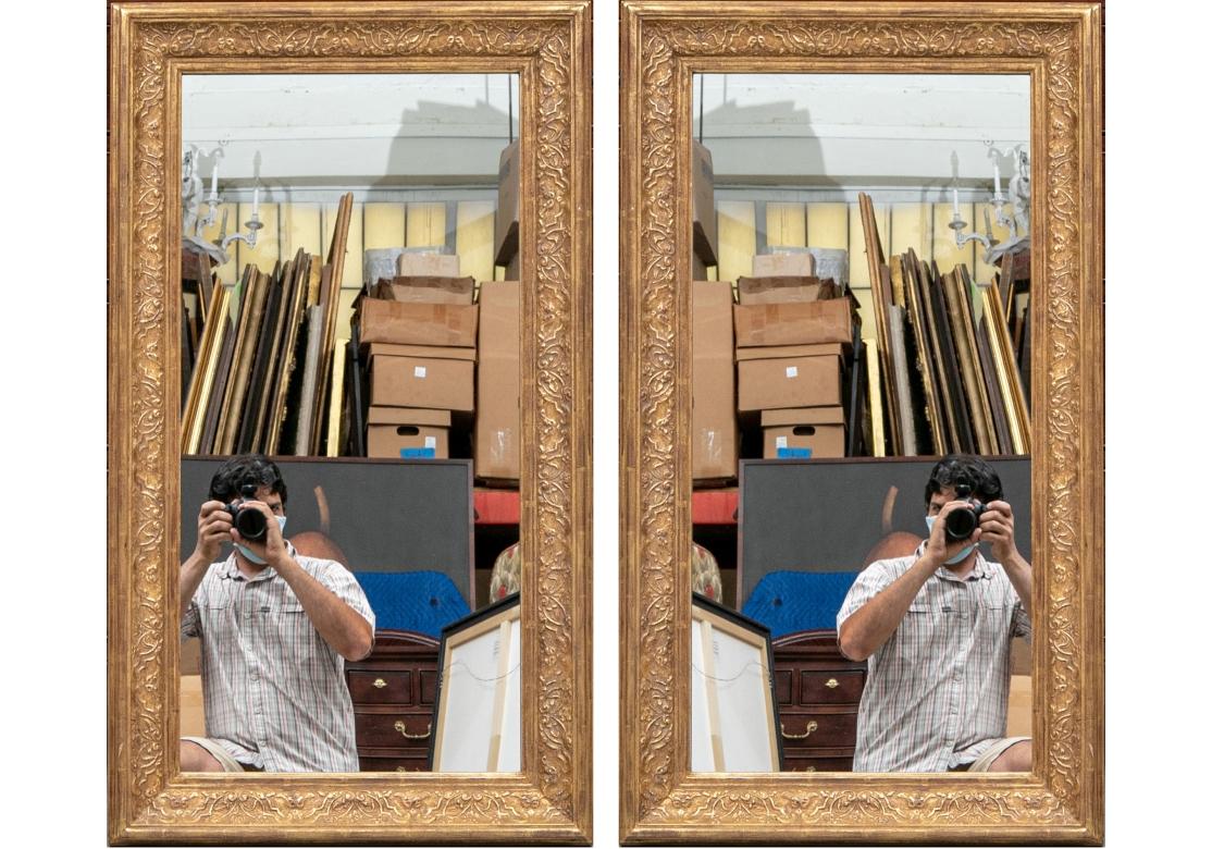 Pair of very fine Wall Mirrors with excellent proportions and very good reflection. With a broad raised foliate scrolled inner surround. In a slightly antiqued finish. By the noted NYC framer Heydenryk. 

Dimensions: 24 x 43