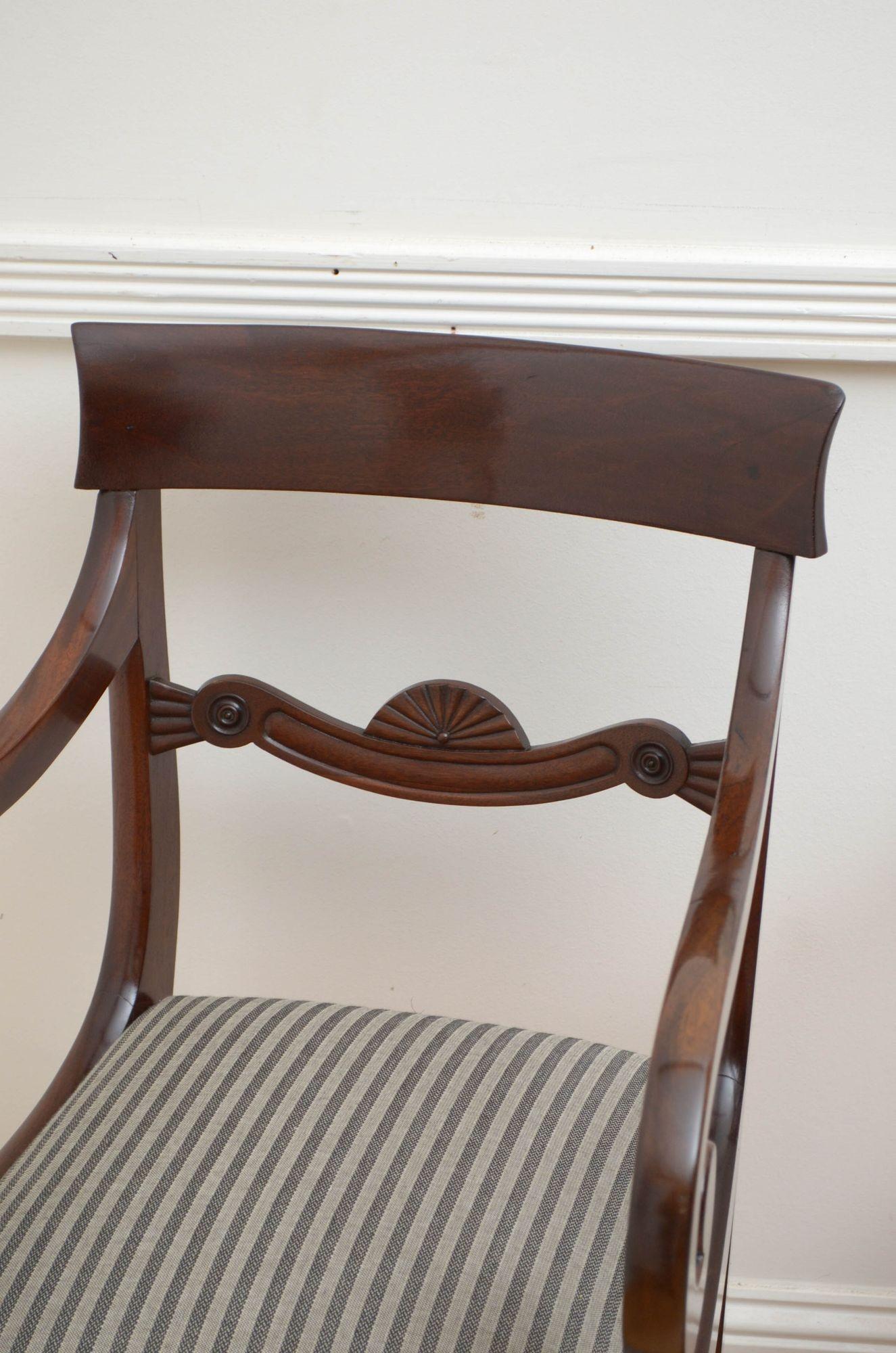 Sn5368 pair of William IV elbow chairs, each having figured mahogany top rail with carved mid rail below and newly recovered drop in seat flanked by open, scroll arms, standing on turned and carved carved legs. This antique pair of chairs is in home