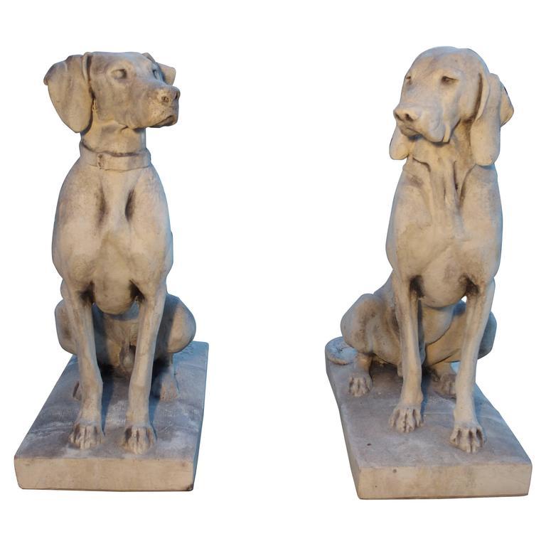 This pair of lifesize dog statues are made of finely cast stone with an antique finish. The quality is high and the proportions are perfect because they were cast from an original iron pair that was borrowed from a historical park in England. The