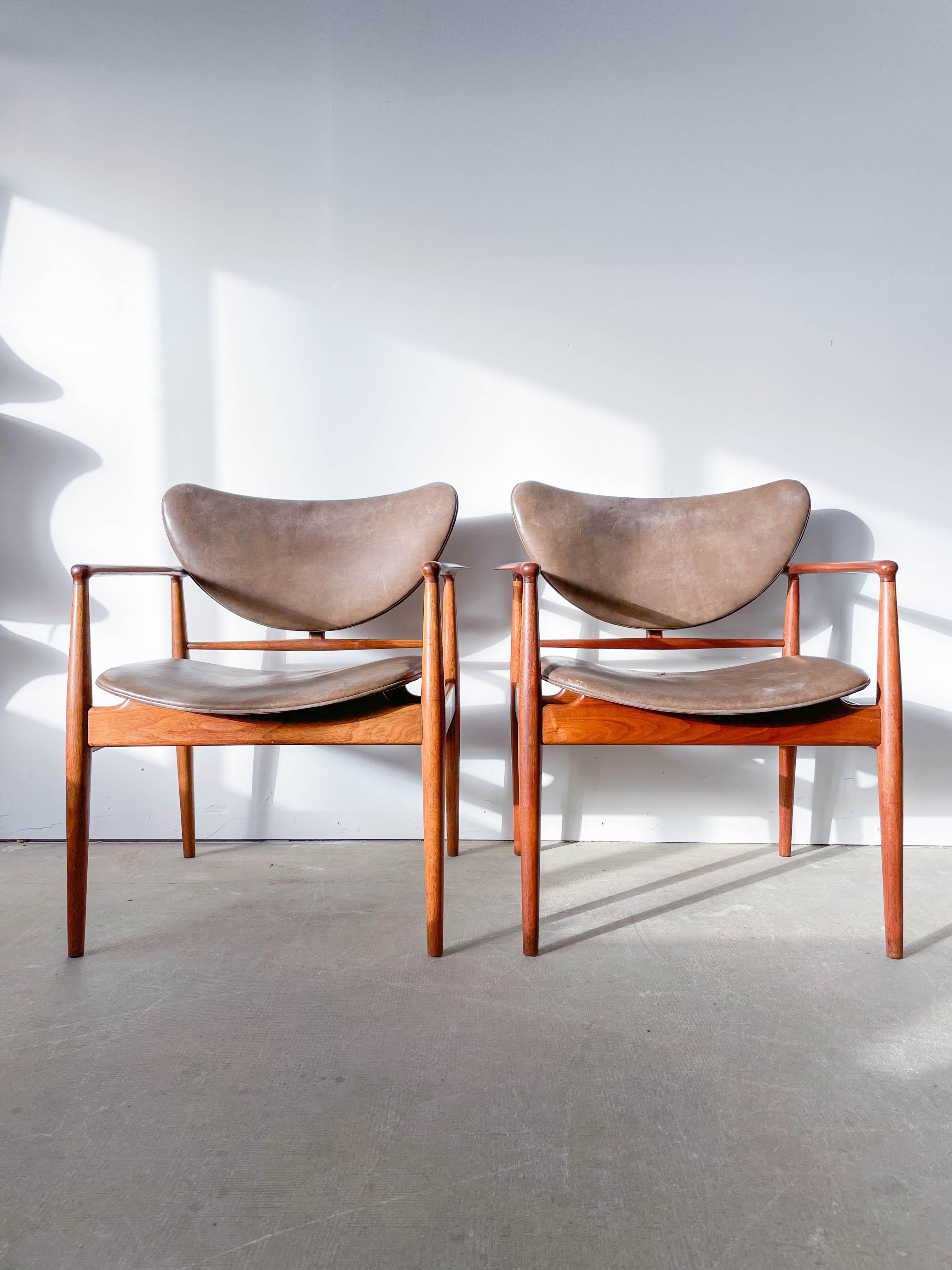 This is an original pair of Finn Juhl’s famous 1948 armchairs produced by Baker Furniture Company in Grand Rapids, Michigan, as part of their fantastic Baker Modern line from 1952-1955. Solid walnut frames are superbly sculpted cradling bent plywood