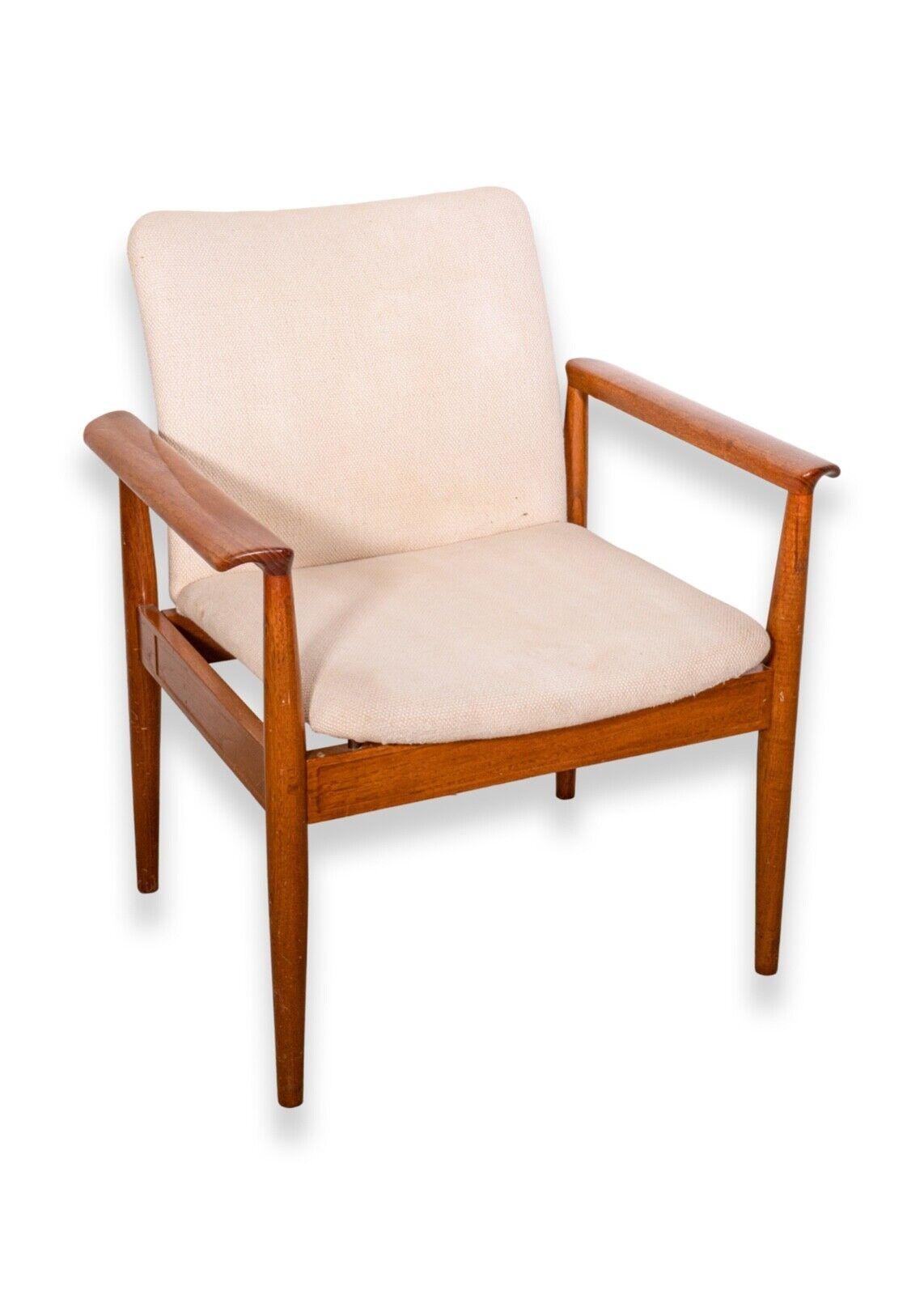 A sophisticated pair of modern armchairs designed by Finn Juhl for France & Son, Denmark. Known as the Diplomat Chair, Model 209. Produced in the 1960s. A sleek teak frame with neutral cream upholstery. Embossed maker's mark on rear stretcher. Finn
