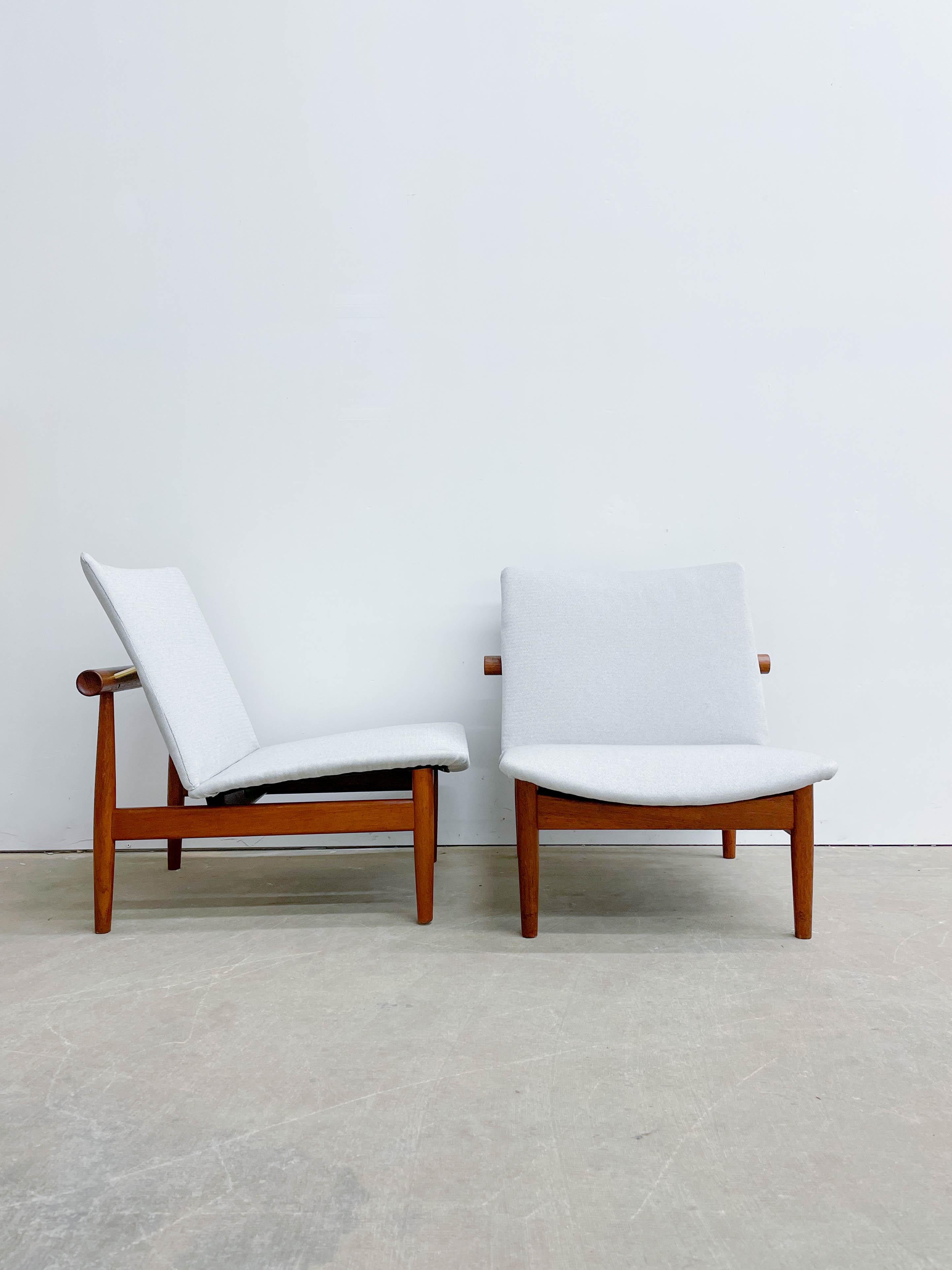 Pair of ‘Japan’ chairs designed by Danish designer Finn Juhl and made by France and Daverkosen in the 1950s. This is a beautiful floating chair design inspired by Torii gates seen outside of Japanese temples -- hence the name! The chair, although a
