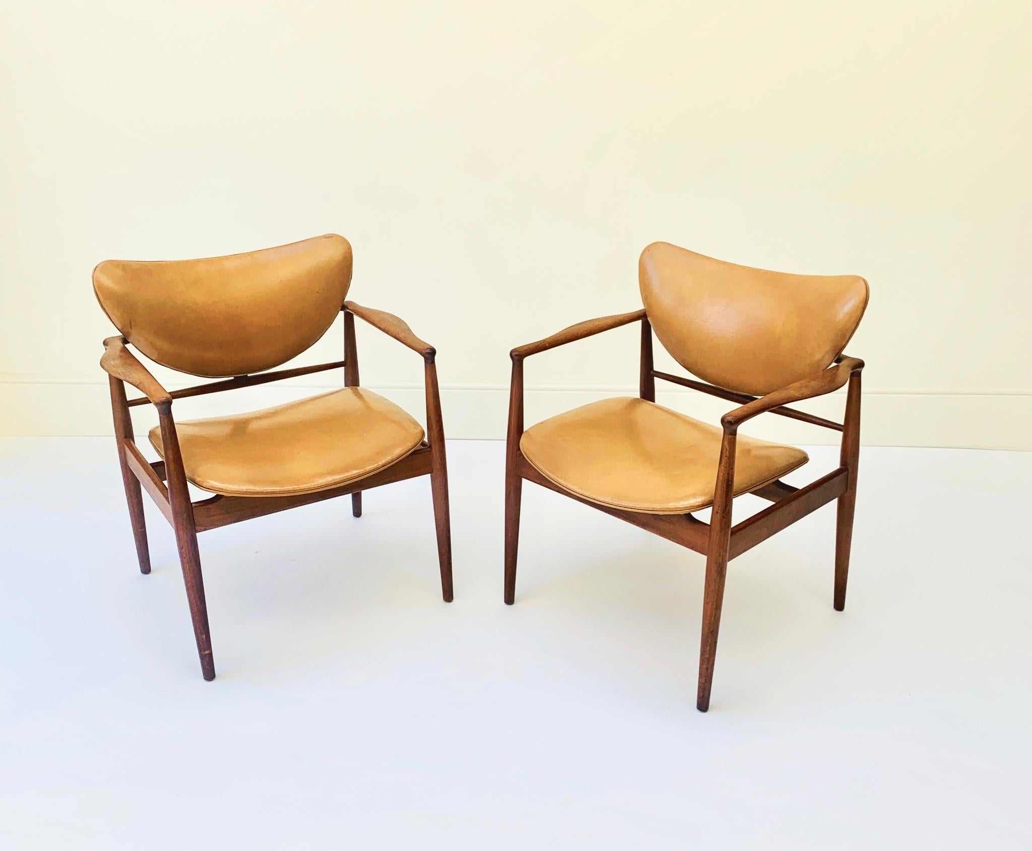 Pair of Finn Juhl model 48 armchairs, 1950s with teak frame and original naugahyde upholstery.