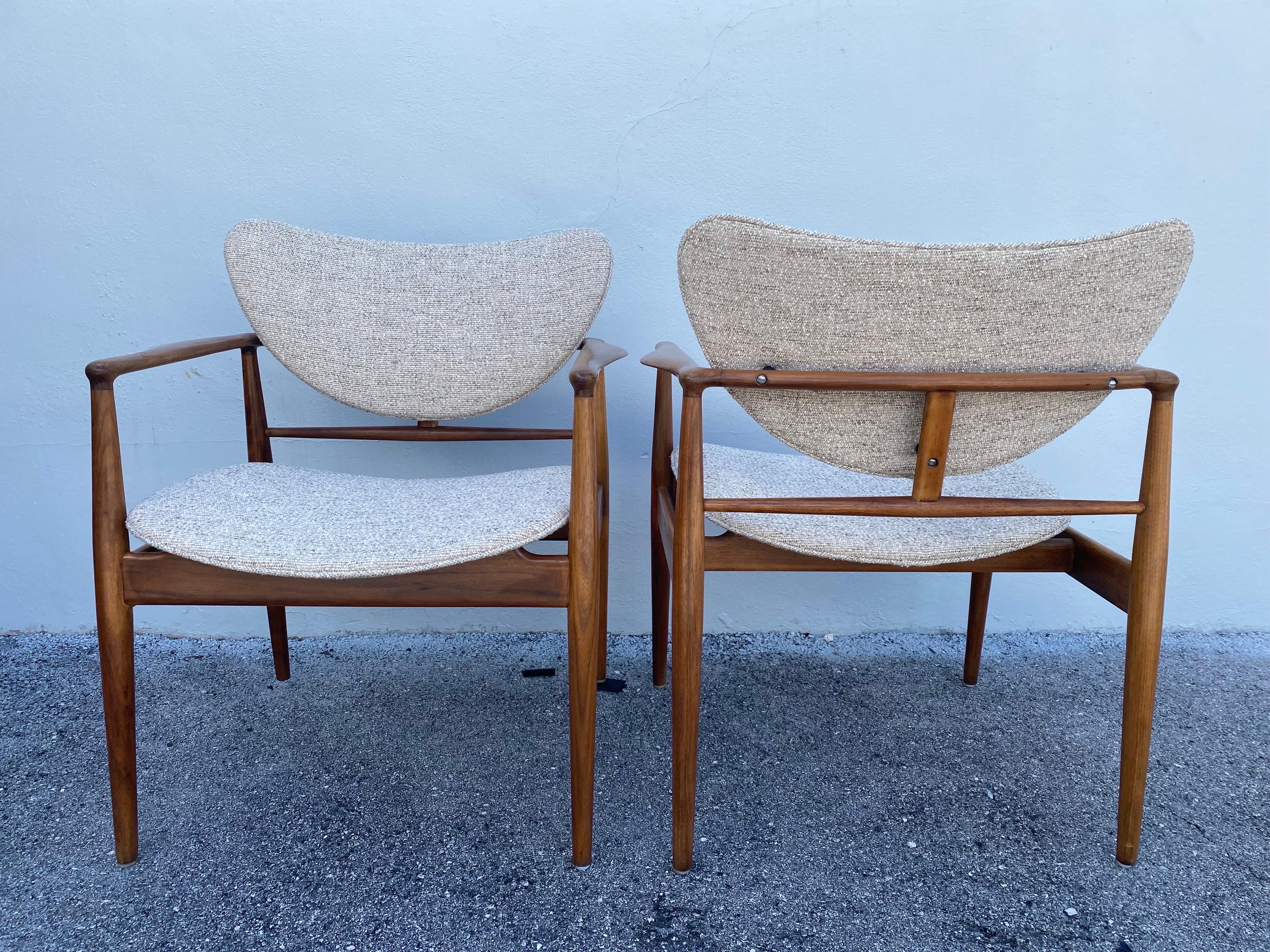 These are a pair of Finn Juhl's 1950's iconic No. 48 open armchairs manufactured by Baker USA - all original with new boucle upholstery. Extremely solid and well made. NOTE: there are three (3) pairs available, sold and priced as pairs.  THIS ITEM