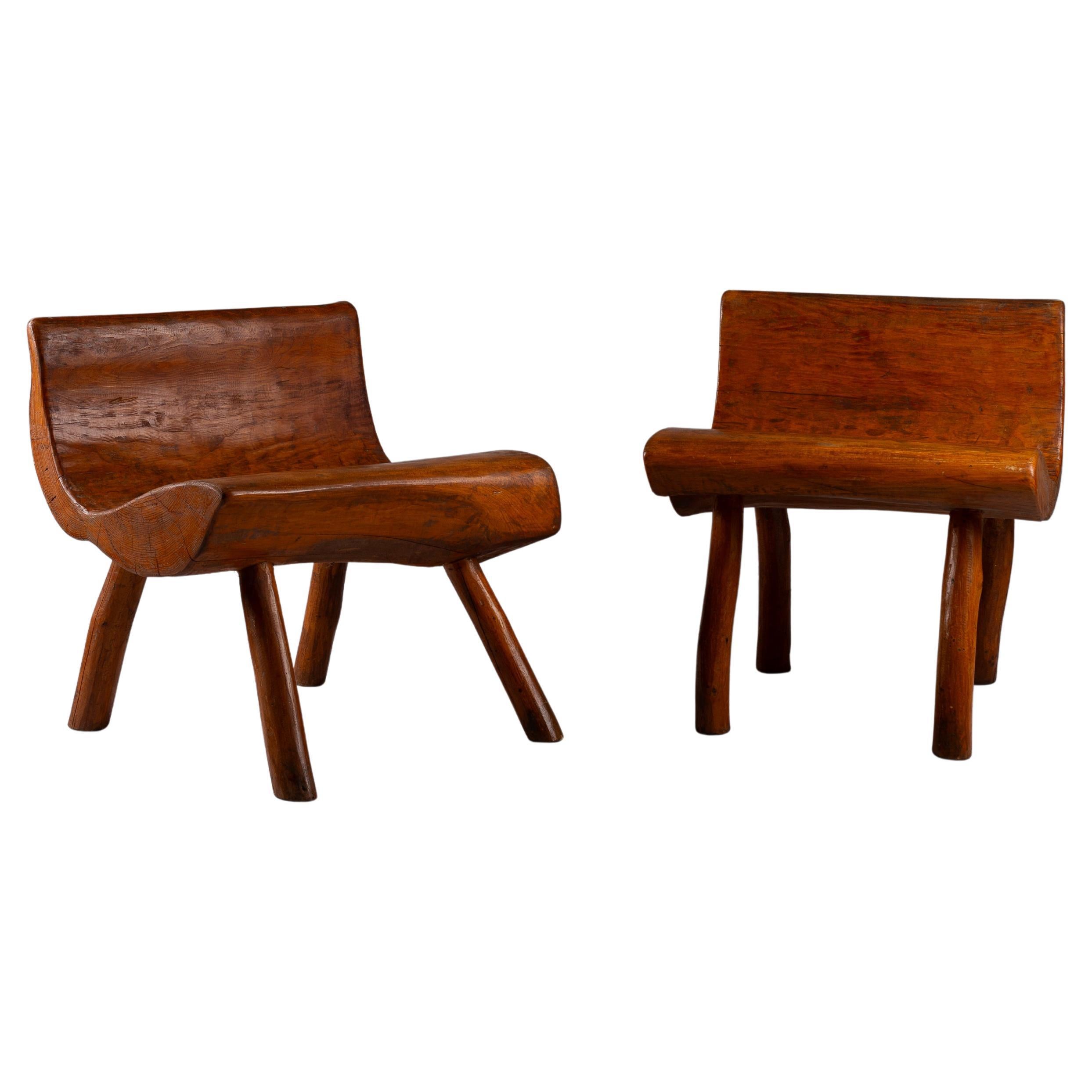 Discover the timeless charm of our Pair of early 20th century brutalist pine chairs. Hand-carved from one piece of wood, these unique pieces showcase extraordinary craftsmanship and an irresistible rugged beauty. Perfect for the hallway, they blend