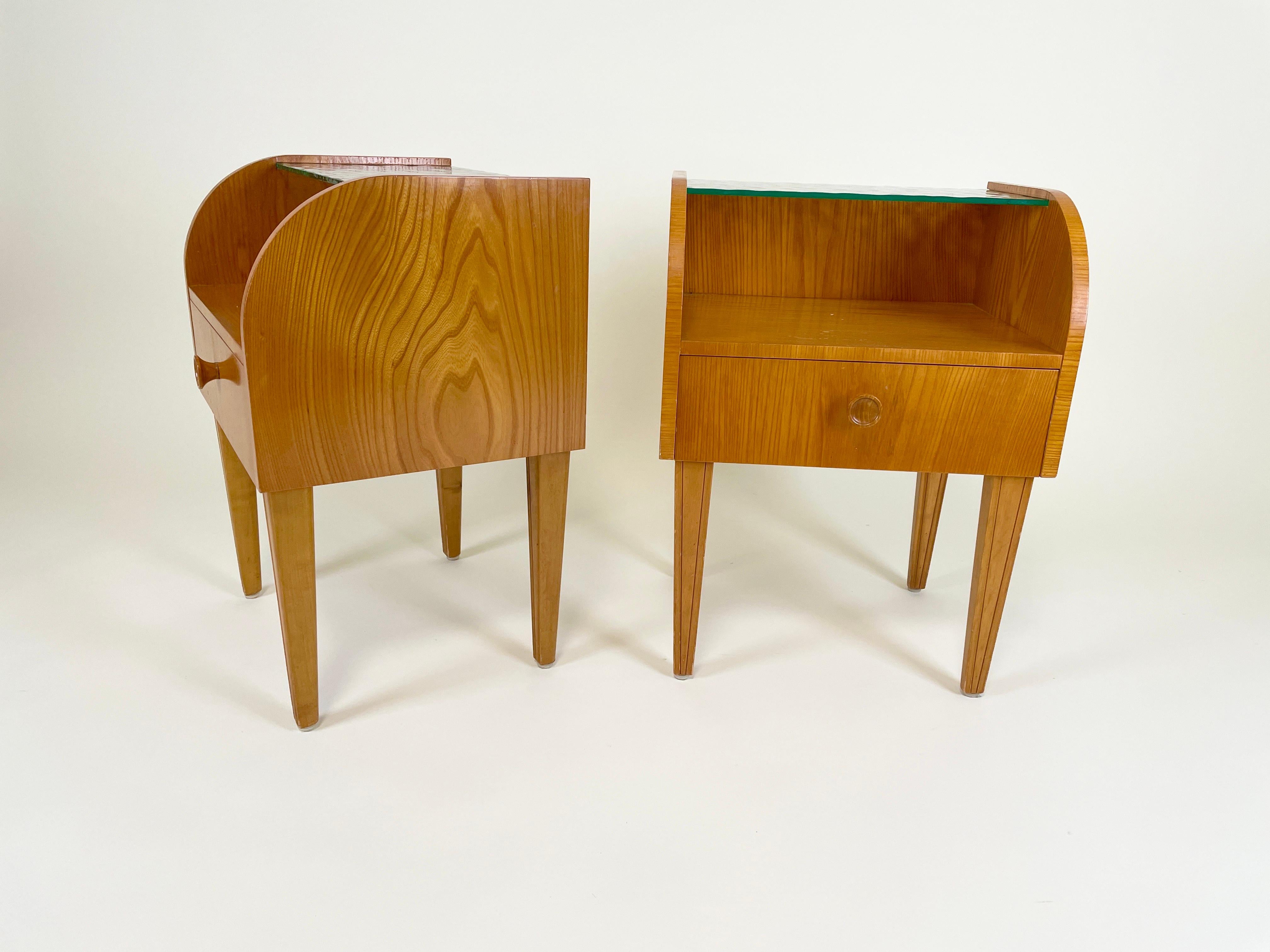 Bring elegance to your bedroom with this timeless pair of Finnish modern bedside tables, attributed to Margaret Travers Nordman in the 1930s and produced by Keravan Puusepäntehdas Oy/Stockmann. These bedside tables showcase seamless blend of