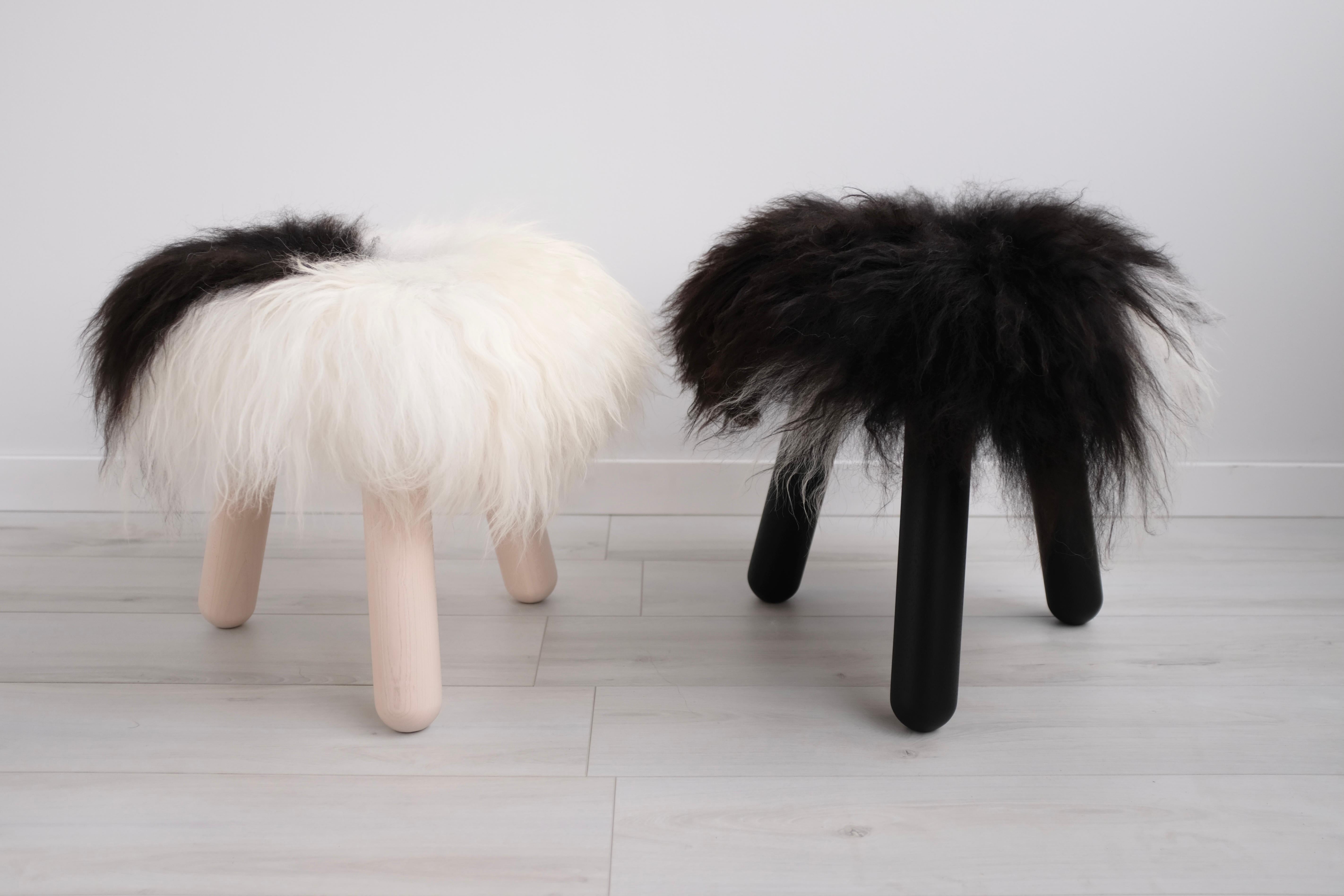A pair of perennially cherished Finny Stools in whitened maple and blackened walnut with complimentary Icelandic Sheep's pelts and cast bronze buttons. Sold as a pair - the perfect Yin and Yang quality here cannot be broken up. Originally designed