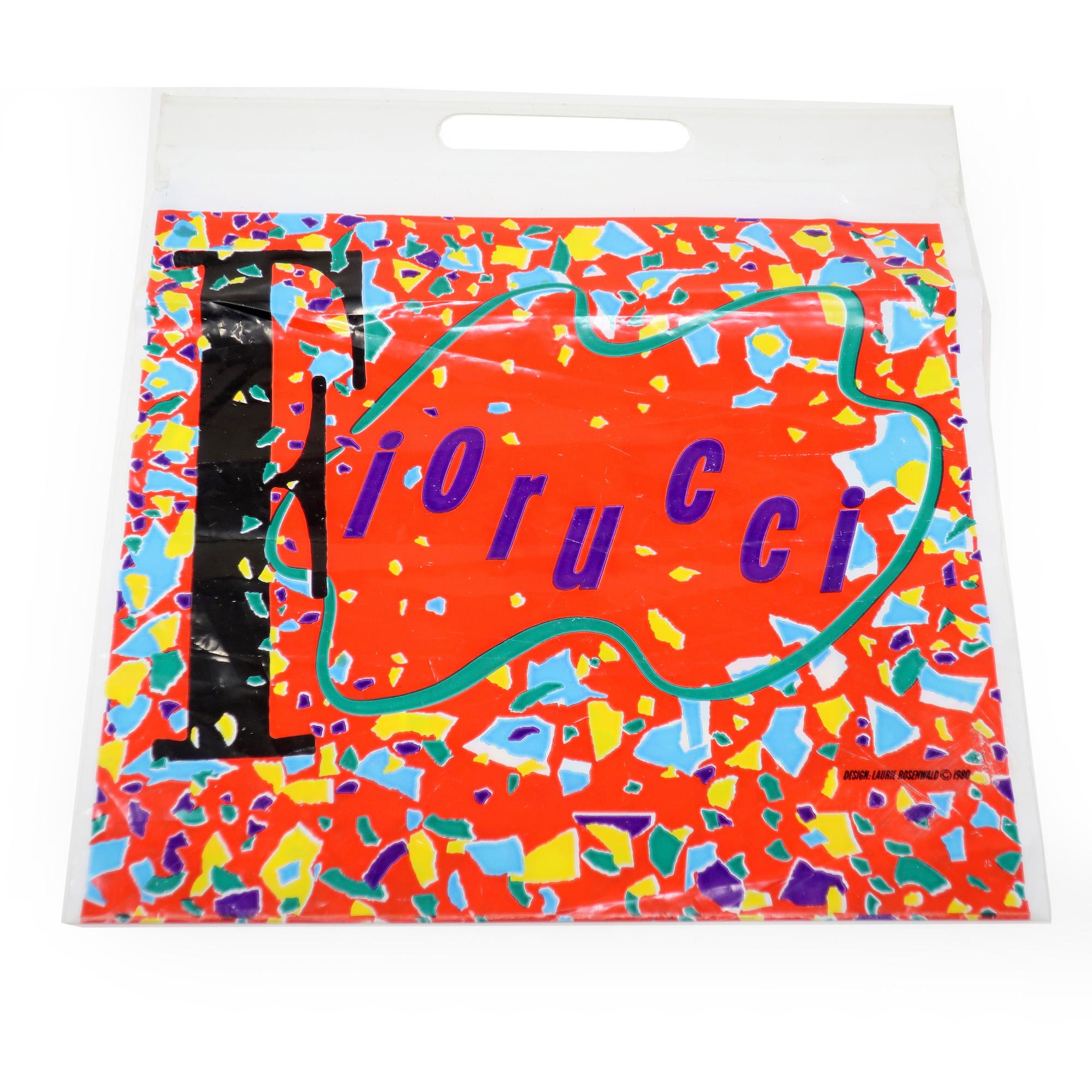 A pair of plastic Fiorucci shopping bags from 1980 designed by Laurie Rosenwald, daughter of sculptor Robert Rosenwald. A perfect time capsule! Rosenwald is a graphic designer, illustrator, and painter known for her bright and playful graphic work.