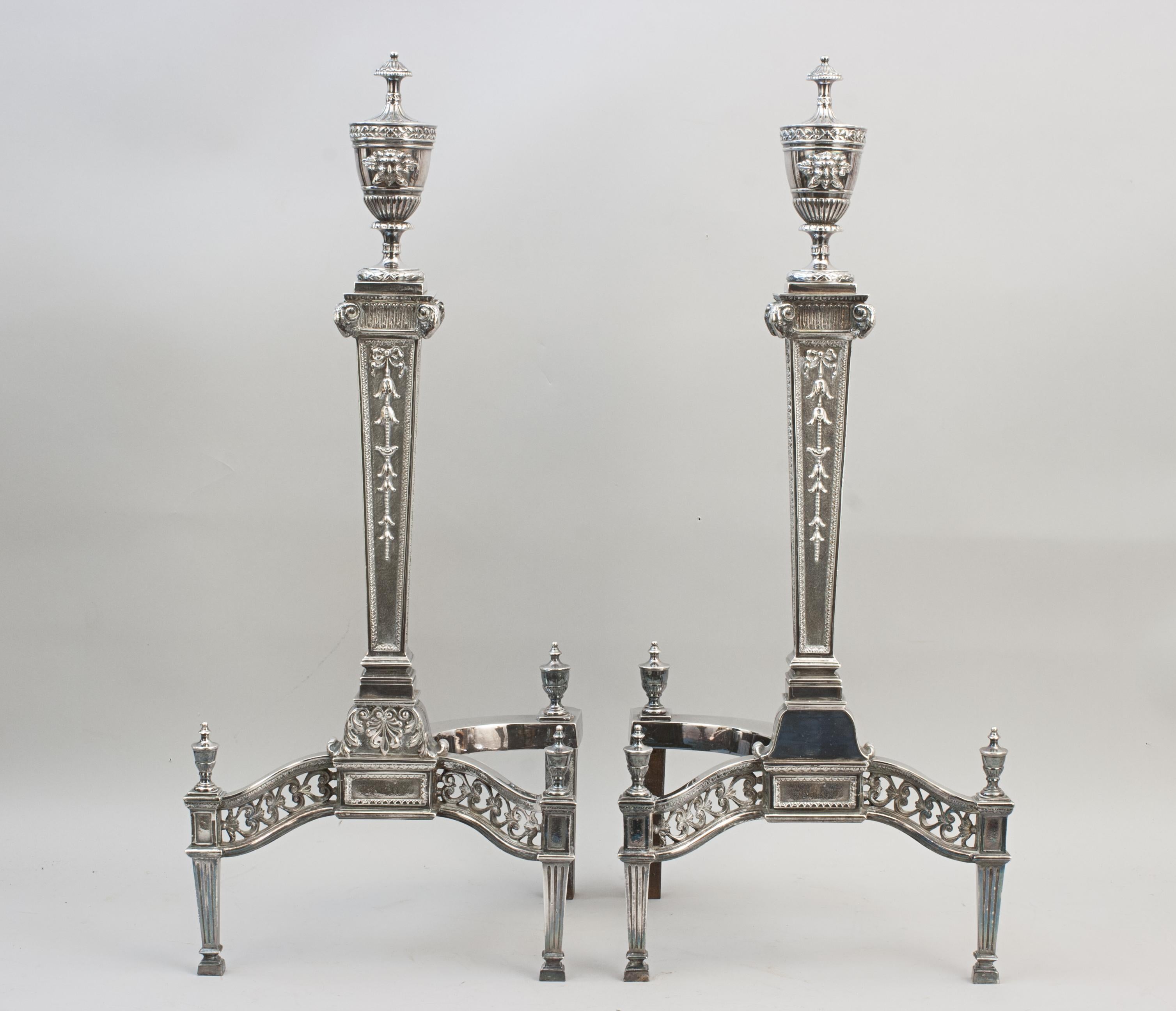 High Quality Plated Firedogs, Andirons, Chenets.
A pair of elegant, tall classical style fire dogs, andirons, with tumbling floral decoration and topped urn finials, the front legs with pierced fret work. If you want your fireplace to be a real