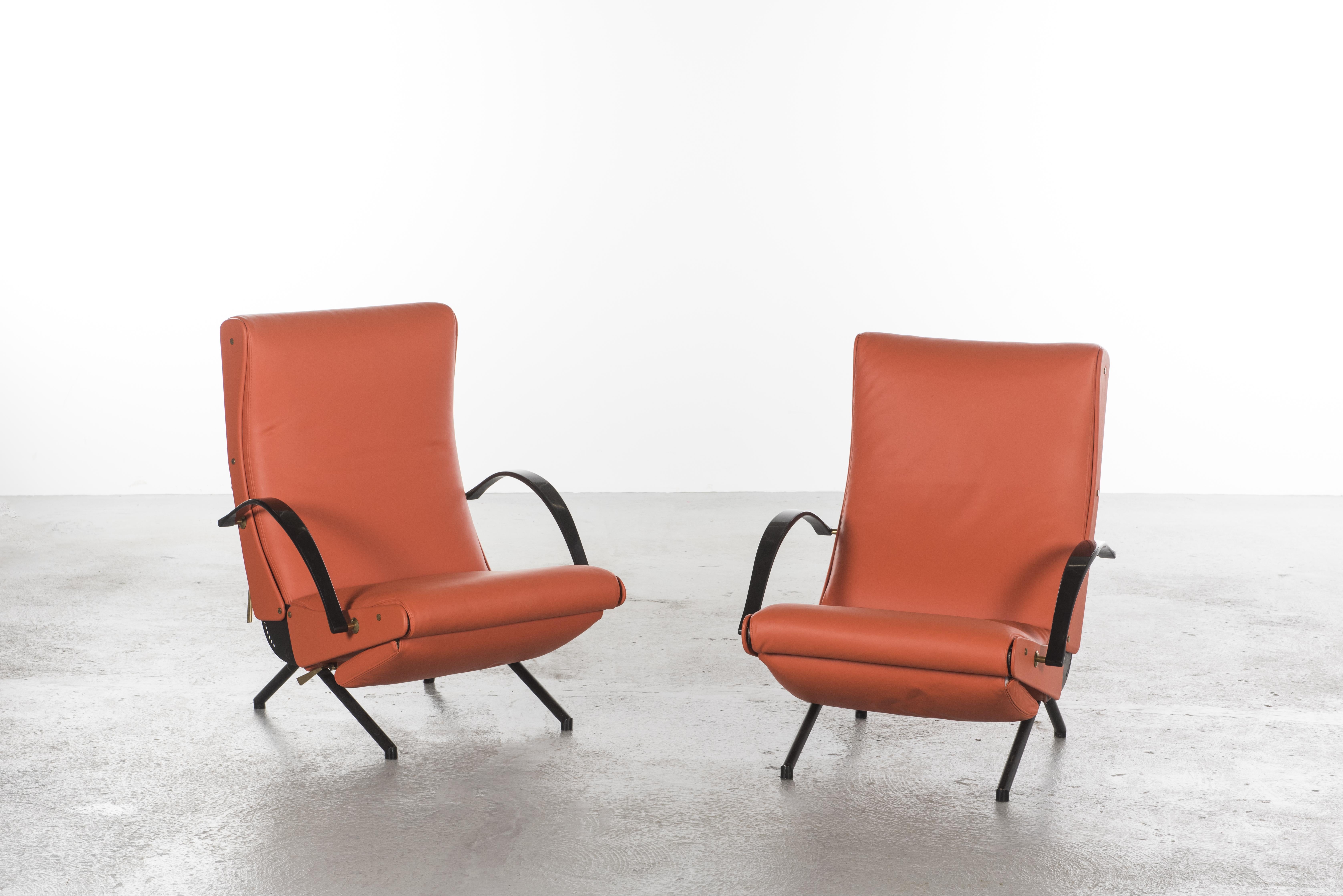 
First edition P40 model lounges chairs by Osvaldo Borsani for Tecno.
This pair is in beautiful orange Hermes color Leather.

This model was produced by Tecno between 1955 and 1959. 
The 1st edition model is different in two points: no
