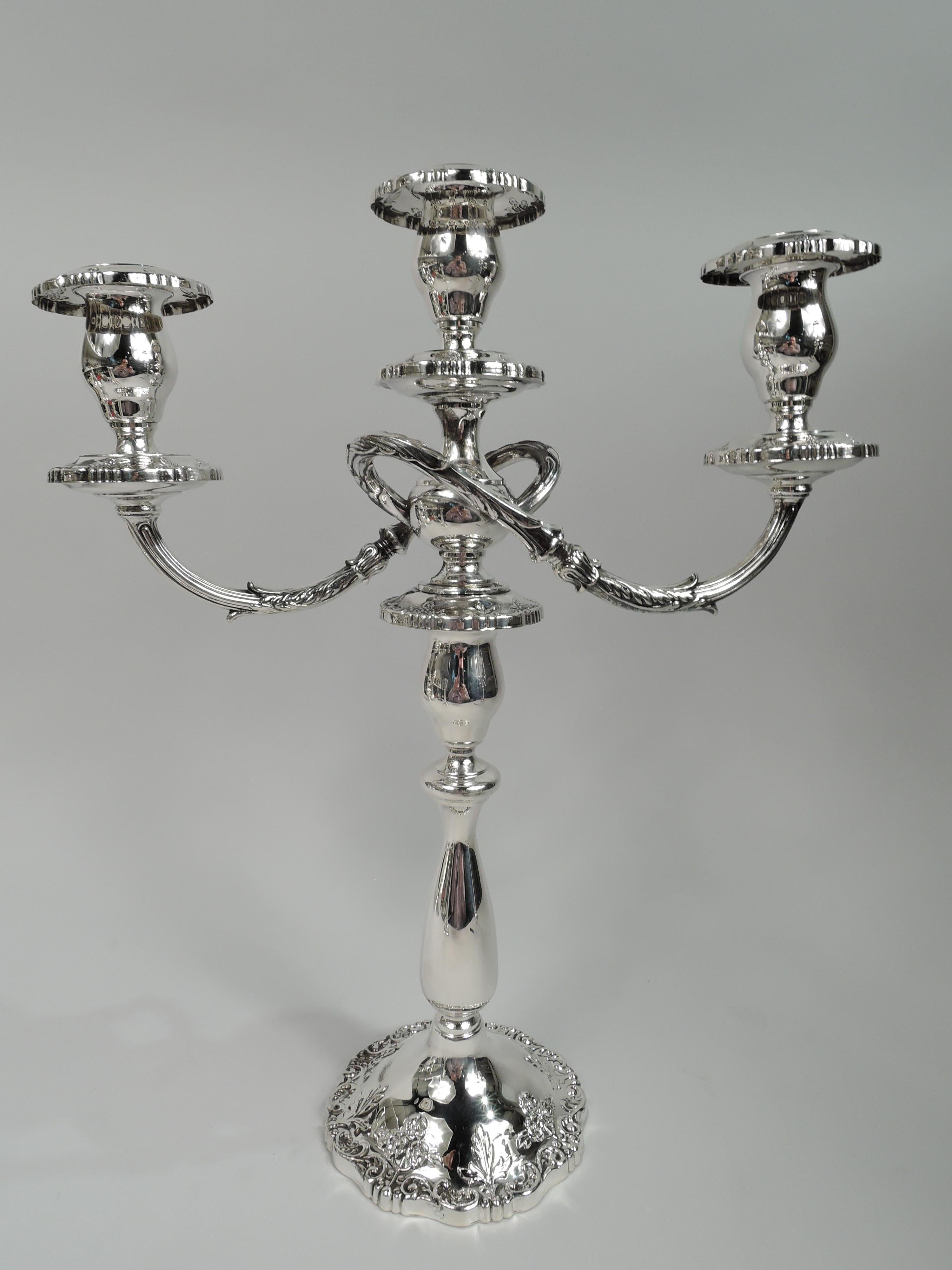 Pair of English Rose sterling silver 3-light candelabra. Made by Fisher in Jersey City, New Jersey. Each: Knopped baluster shaft on raised foot. Central socket and 2 wraparound leaf-wrapped and reeded arms, each terminating in single socket. Sockets